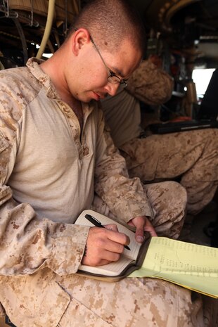 Cpl. Andrew S. Black, a ground radio intermediate repairer with 2nd Marine Logistics Group (Forward), writes down serial numbers and other information about radios before performing maintenance and installing upgrades at Forward Operating Base Marjah, Afghanistan, July 28, 2011.  Black is part of a three-man communication team that travels around Helmand province maintaining radios and other communication devices for explosive ordnance disposal teams.