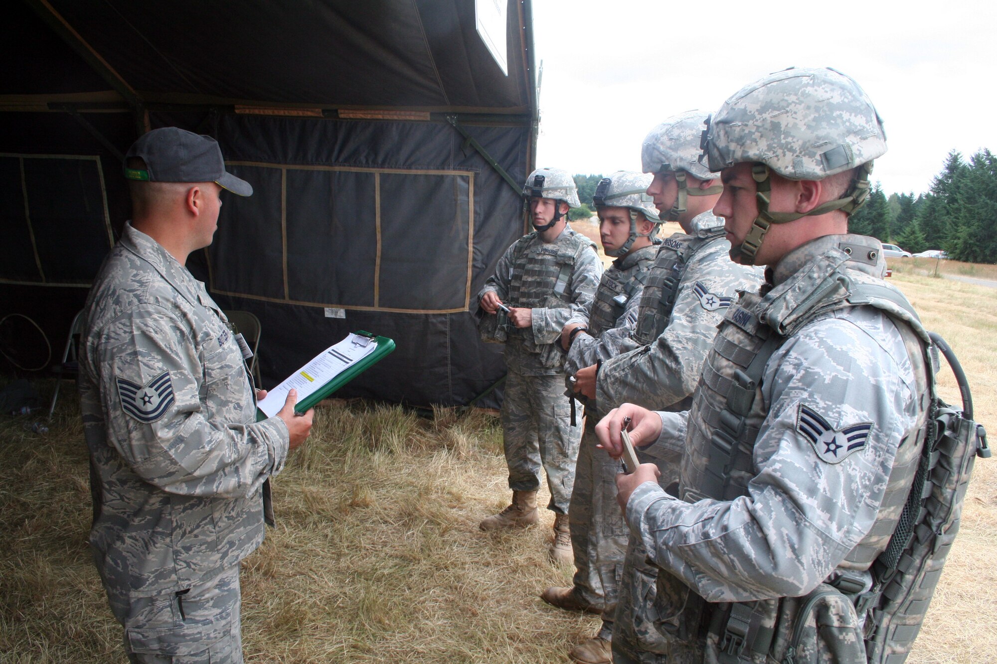 Tech. Sgt. Matt Butler briefs a security forces team during the security forces tactics team competition for Air Mobility Rodeo 2011 on July 26, 2011, at Joint Base Lewis-McChord, Wash. Butler is from the 421st Combat Training Squadron at Joint Base McGuire-Dix-Lakehurst, N.J. Rodeo 2011, sponsored by the Air Mobility Command, is the Mobility Air Force's readiness competition. This competition focuses on improving worldwide air mobility forces' professional core abilities. More than 150 teams and 3,000 people from the Air Force, and Air Force Reserve, as well as allied nations are participating in Rodeo. (U.S. Air Force Photo/Master Sgt. Scott T. Sturkol)