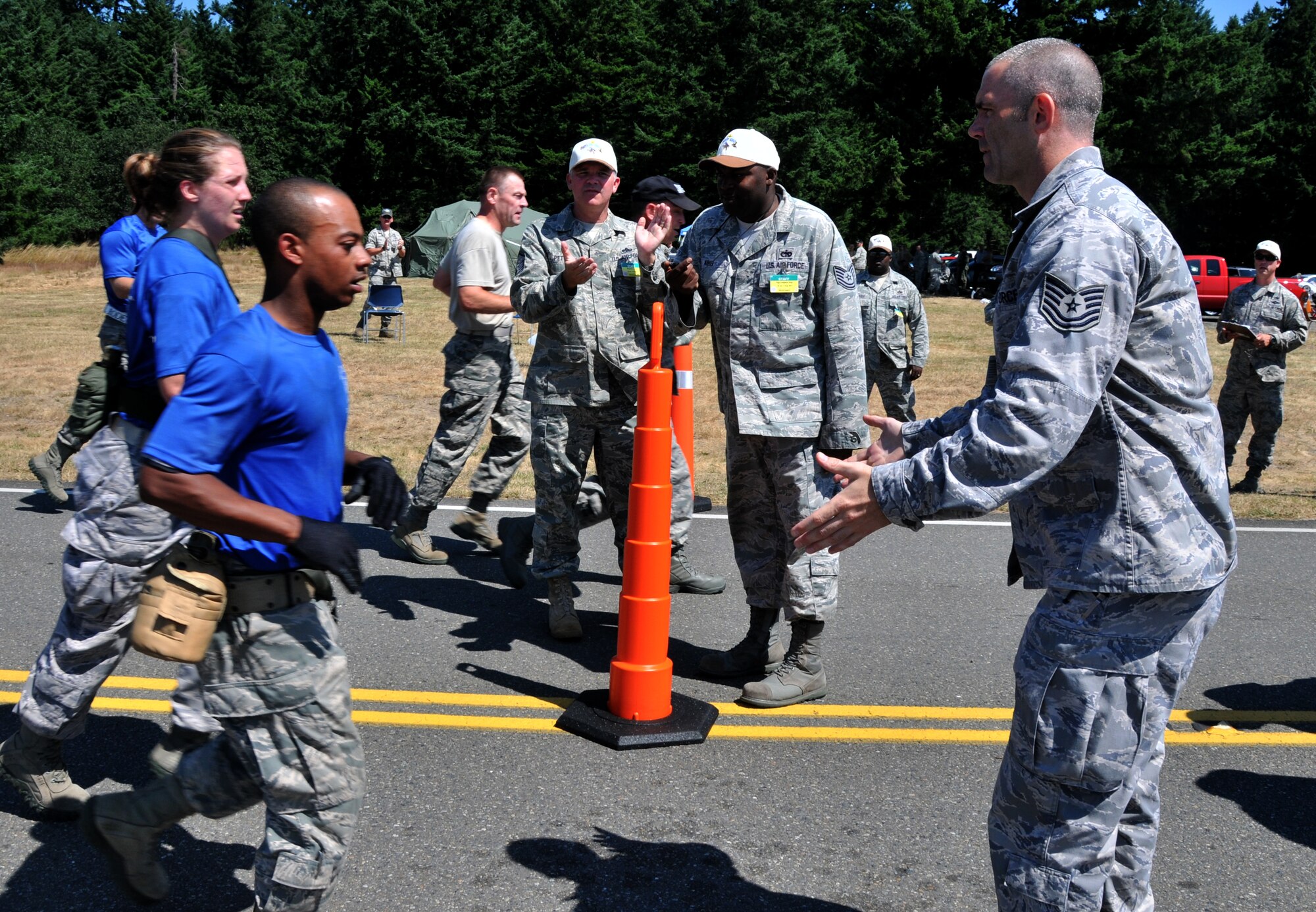 Airmen race to the finish line, July 28, 2011 at Joint Base Lewis-McChord, Wash., during an aerial port obstacle course. The event was part of Air Mobility Rodeo 2011, a biennial international competition that focuses on mission readiness, featuring airdrops, aerial refueling and other events that showcase the skills of mobility crews from around the world. (U.S. Air Force photo/Airman 1st Class Jared Trimarchi) 
