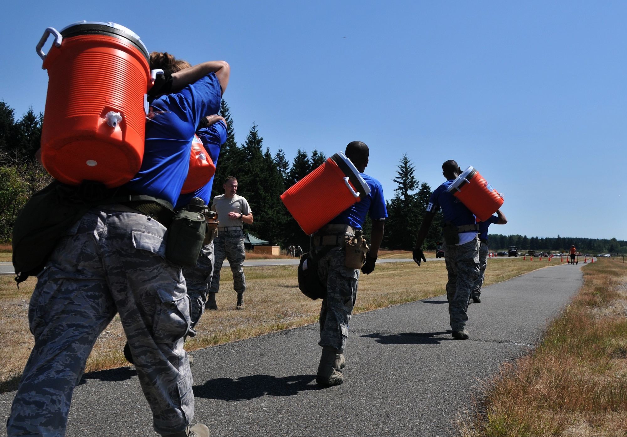 Airmen haul water jugs, July 28, 2011 at Joint Base Lewis-McChord, Wash., during an aerial port obstacle course. The event was part of Air Mobility Rodeo 2011, a biennial international competition that focuses on mission readiness, featuring airdrops, aerial refueling and other events that showcase the skills of mobility crews from around the world. (U.S. Air Force photo/Airman 1st Class Jared Trimarchi) 
