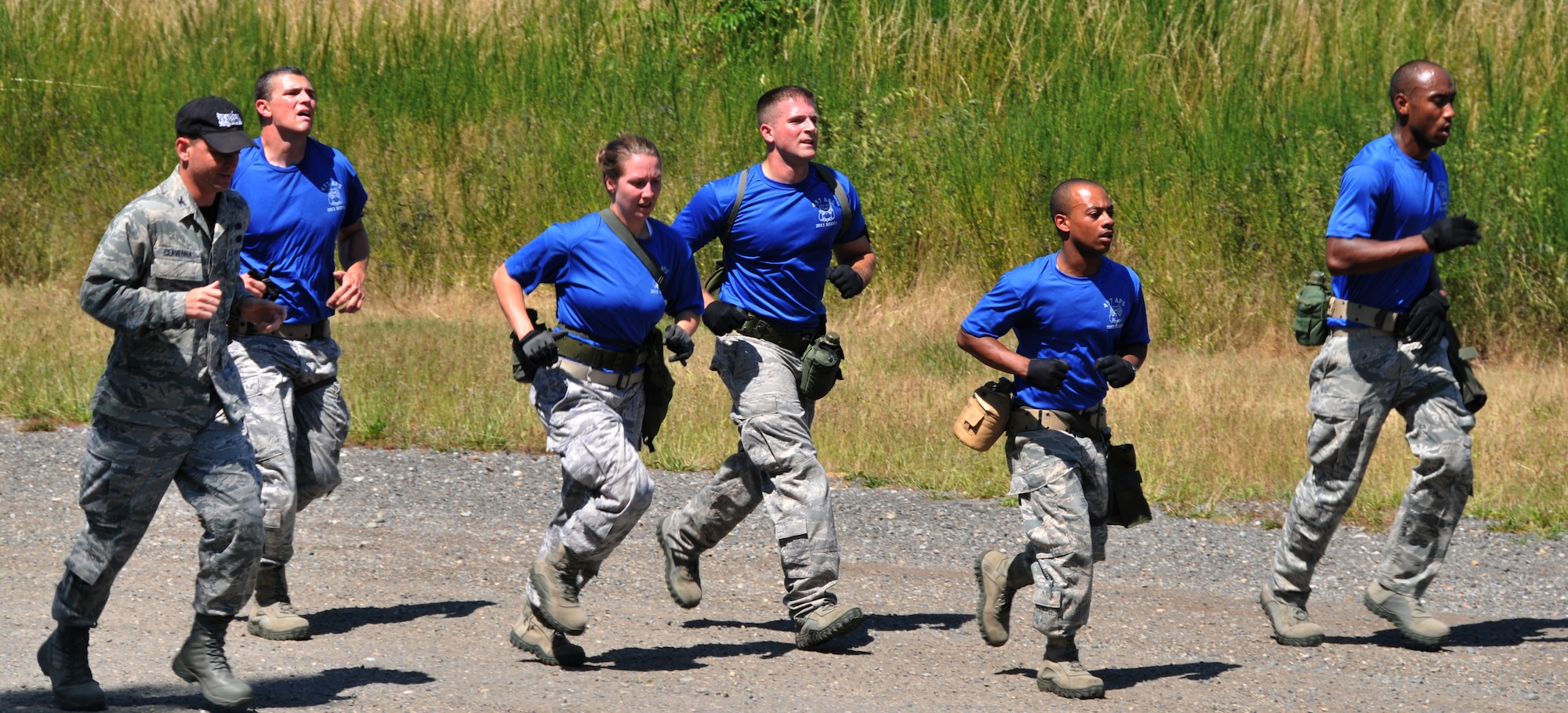 Airmen run next to their commander, July 28, 2011 at Joint Base Lewis-McChord, Wash., during an aerial port obstacle course. The event was part of Air Mobility Rodeo 2011, a biennial international competition that focuses on mission readiness, featuring airdrops, aerial refueling and other events that showcase the skills of mobility crews from around the world. (U.S. Air Force photo/Airman 1st Class Jared Trimarchi) 
