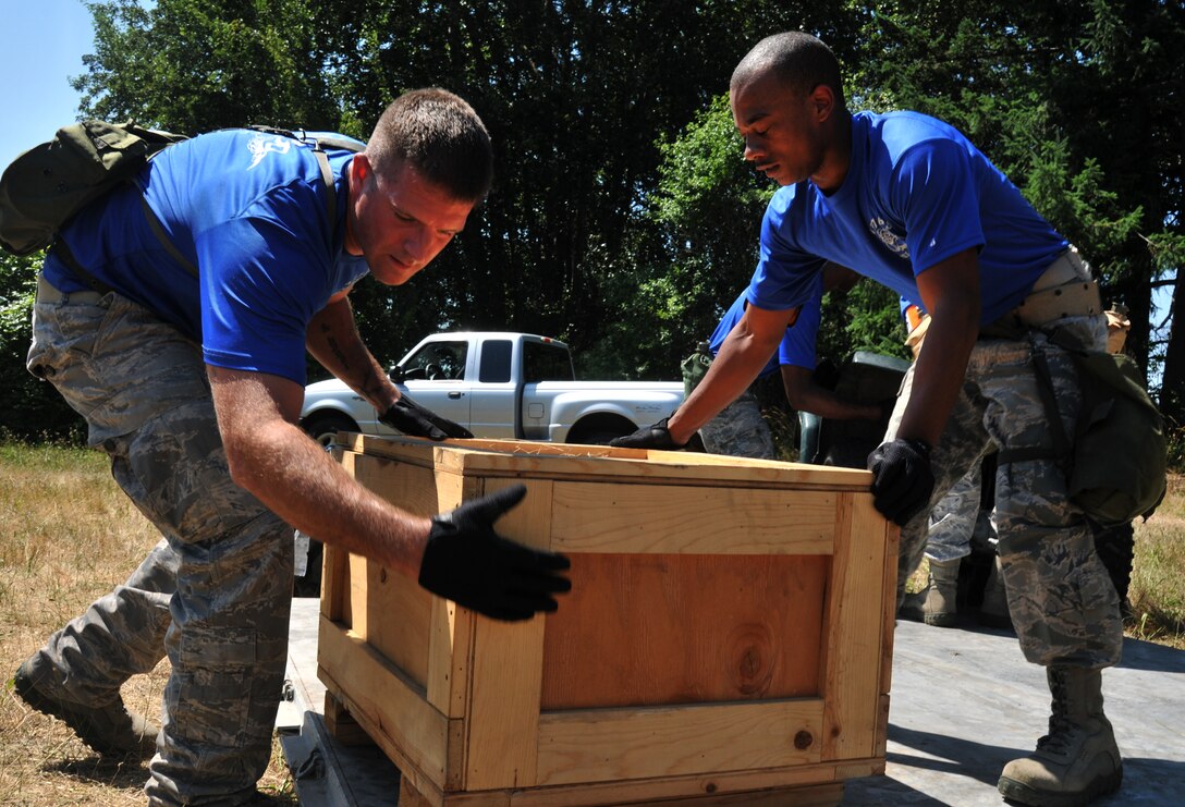 Airmen stack a box on a pallet, July 28, 2011 at Joint Base Lewis-McChord, Wash., during an aerial port obstacle course. The event was part of Air Mobility Rodeo 2011, a biennial international competition that focuses on mission readiness, featuring airdrops, aerial refueling and other events that showcase the skills of mobility crews from around the world. (U.S. Air Force photo/Airman 1st Class Jared Trimarchi) ) 