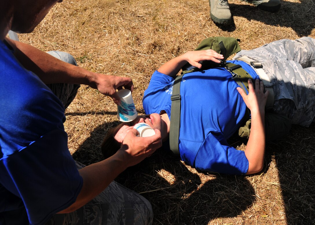 An Airman poses as a wounded troop, July 28, 2011 at Joint Base Lewis-McChord, Wash., during an aerial port obstacle course. The event was part of Air Mobility Rodeo 2011, a biennial international competition that focuses on mission readiness, featuring airdrops, aerial refueling and other events that showcase the skills of mobility crews from around the world. (U.S. Air Force photo/Airman 1st Class Jared Trimarchi)  