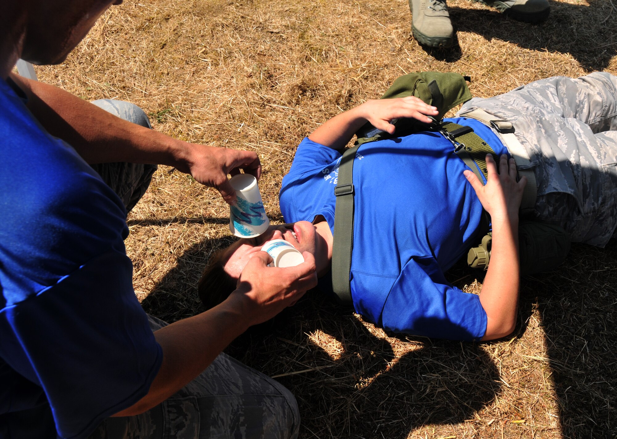 An Airman poses as a wounded troop, July 28, 2011 at Joint Base Lewis-McChord, Wash., during an aerial port obstacle course. The event was part of Air Mobility Rodeo 2011, a biennial international competition that focuses on mission readiness, featuring airdrops, aerial refueling and other events that showcase the skills of mobility crews from around the world. (U.S. Air Force photo/Airman 1st Class Jared Trimarchi) 
 