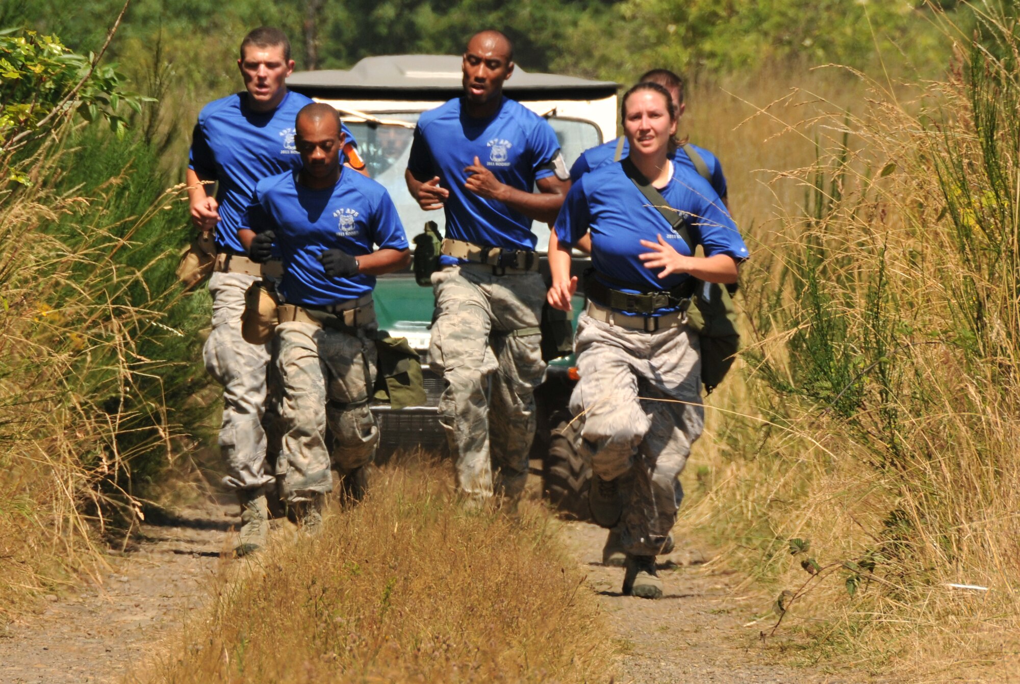 Airmen run in rough terrain, July 28, 2011 at Joint Base Lewis-McChord, Wash., during an aerial port obstacle course. The event was part of Air Mobility Rodeo 2011, a biennial international competition that focuses on mission readiness, featuring airdrops, aerial refueling and other events that showcase the skills of mobility crews from around the world. (U.S. Air Force photo/Airman 1st Class Jared Trimarchi) 
 