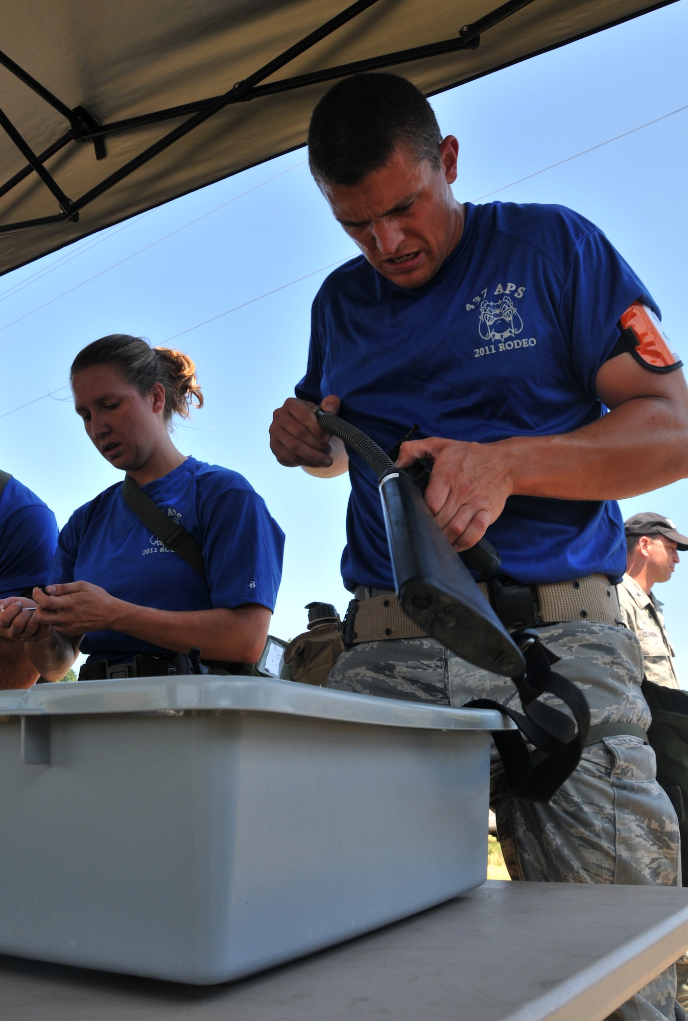An Airman pieces together an M-16, July 28, 2011 at Joint Base Lewis-McChord, Wash., during an aerial port obstacle course. The event was part of Air Mobility Rodeo 2011, a biennial international competition that focuses on mission readiness, featuring airdrops, aerial refueling and other events that showcase the skills of mobility crews from around the world. (U.S. Air Force photo/Airman 1st Class Jared Trimarchi) 
