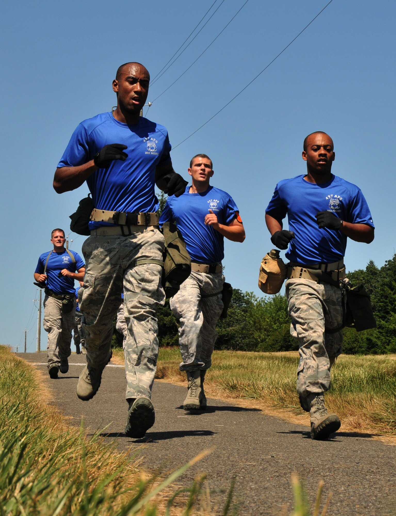Airmen run down a hill, July 28, 2011 at Joint Base Lewis-McChord, Wash., during an aerial port obstacle course. The event was part of Air Mobility Rodeo 2011, a biennial international competition that focuses on mission readiness, featuring airdrops, aerial refueling and other events that showcase the skills of mobility crews from around the world. (U.S. Air Force photo/Airman 1st Class Jared Trimarchi) 
