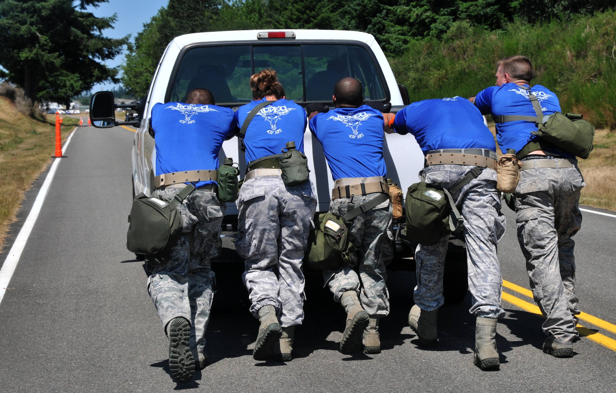 Airmen move a truck, July 28, 2011 at Joint Base Lewis-McChord, Wash., during an aerial port obstacle course. The event was part of Air Mobility Rodeo 2011, a biennial international competition that focuses on mission readiness, featuring airdrops, aerial refueling and other events that showcase the skills of mobility crews from around the world. (U.S. Air Force photo/Airman 1st Class Jared Trimarchi) 
