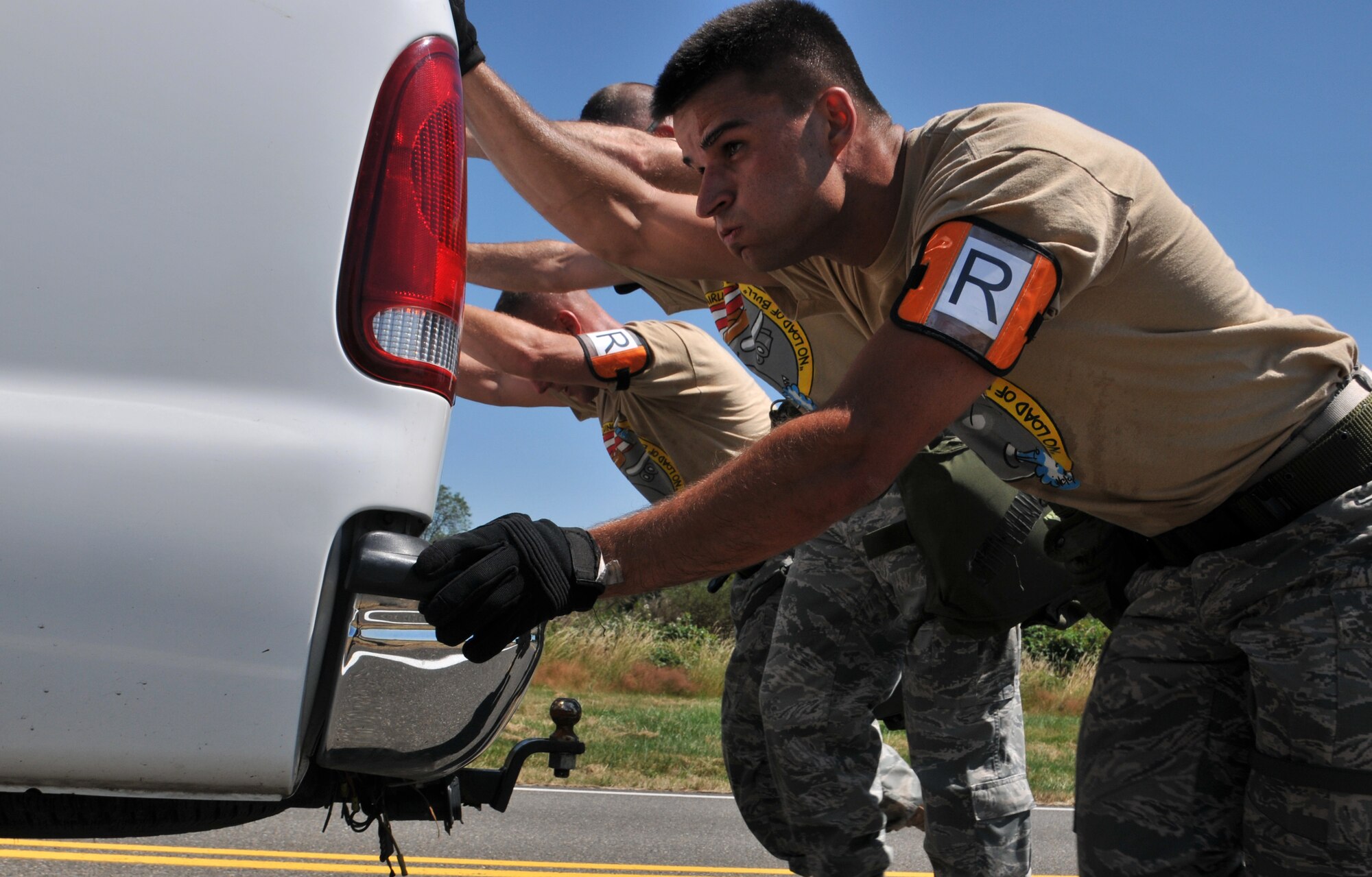 Airmen push a truck, July 28, 2011 at Joint Base Lewis-McChord, Wash., during an aerial port obstacle course. The event was part of Air Mobility Rodeo 2011, a biennial international competition that focuses on mission readiness, featuring airdrops, aerial refueling and other events that showcase the skills of mobility crews from around the world. (U.S. Air Force photo/Airman 1st Class Jared Trimarchi) 
