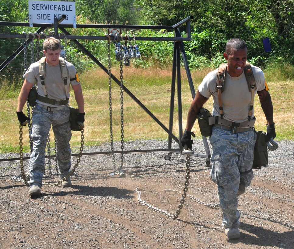 Airmen drag tie-down chains, July 28, 2011 at Joint Base Lewis-McChord, Wash., during an aerial port obstacle course. The event was part of Air Mobility Rodeo 2011, a biennial international competition that focuses on mission readiness, featuring airdrops, aerial refueling and other events that showcase the skills of mobility crews from around the world. (U.S. Air Force photo/Airman 1st Class Jared Trimarchi) 
