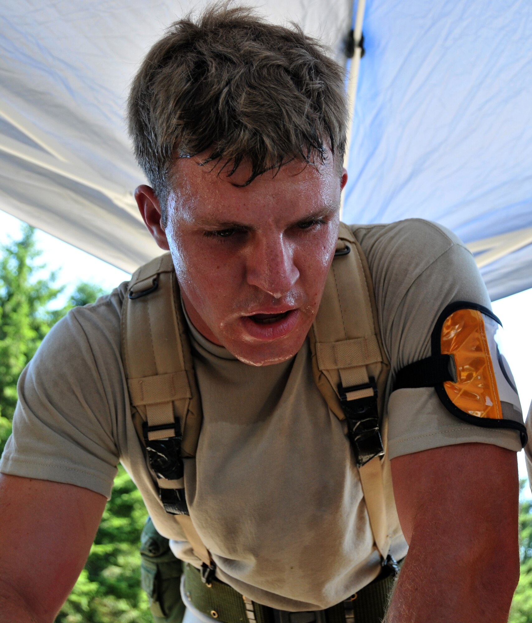 An Airman sweats, July 28, 2011 at Joint Base Lewis-McChord, Wash., during an aerial port obstacle course. The event was part of Air Mobility Rodeo 2011, a biennial international competition that focuses on mission readiness, featuring airdrops, aerial refueling and other events that showcase the skills of mobility crews from around the world. (U.S. Air Force photo/Airman 1st Class Jared Trimarchi) 
