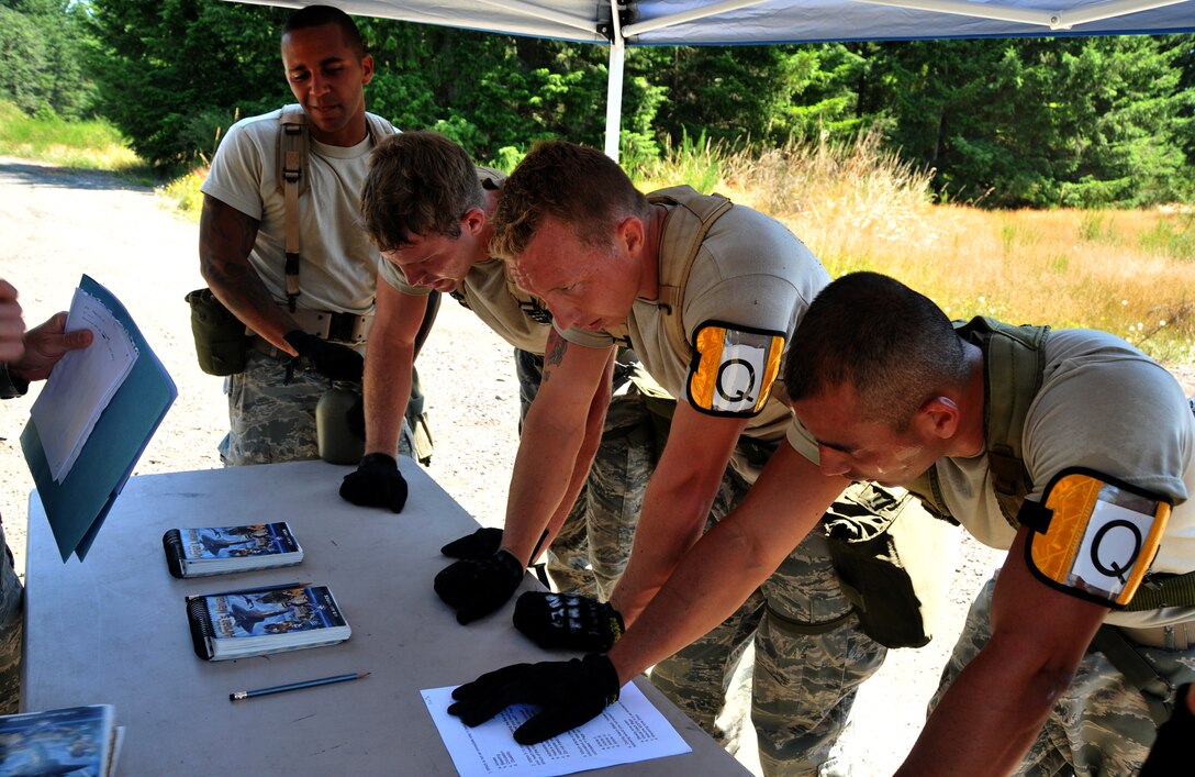 Airmen catch their breaths before taking a five-question test, July 28, 2011 at Joint Base Lewis-McChord, Wash., during an aerial port obstacle course. The event was part of Air Mobility Rodeo 2011, a biennial international competition that focuses on mission readiness, featuring airdrops, aerial refueling and other events that showcase the skills of mobility crews from around the world. (U.S. Air Force photo/Airman 1st Class Jared Trimarchi) 