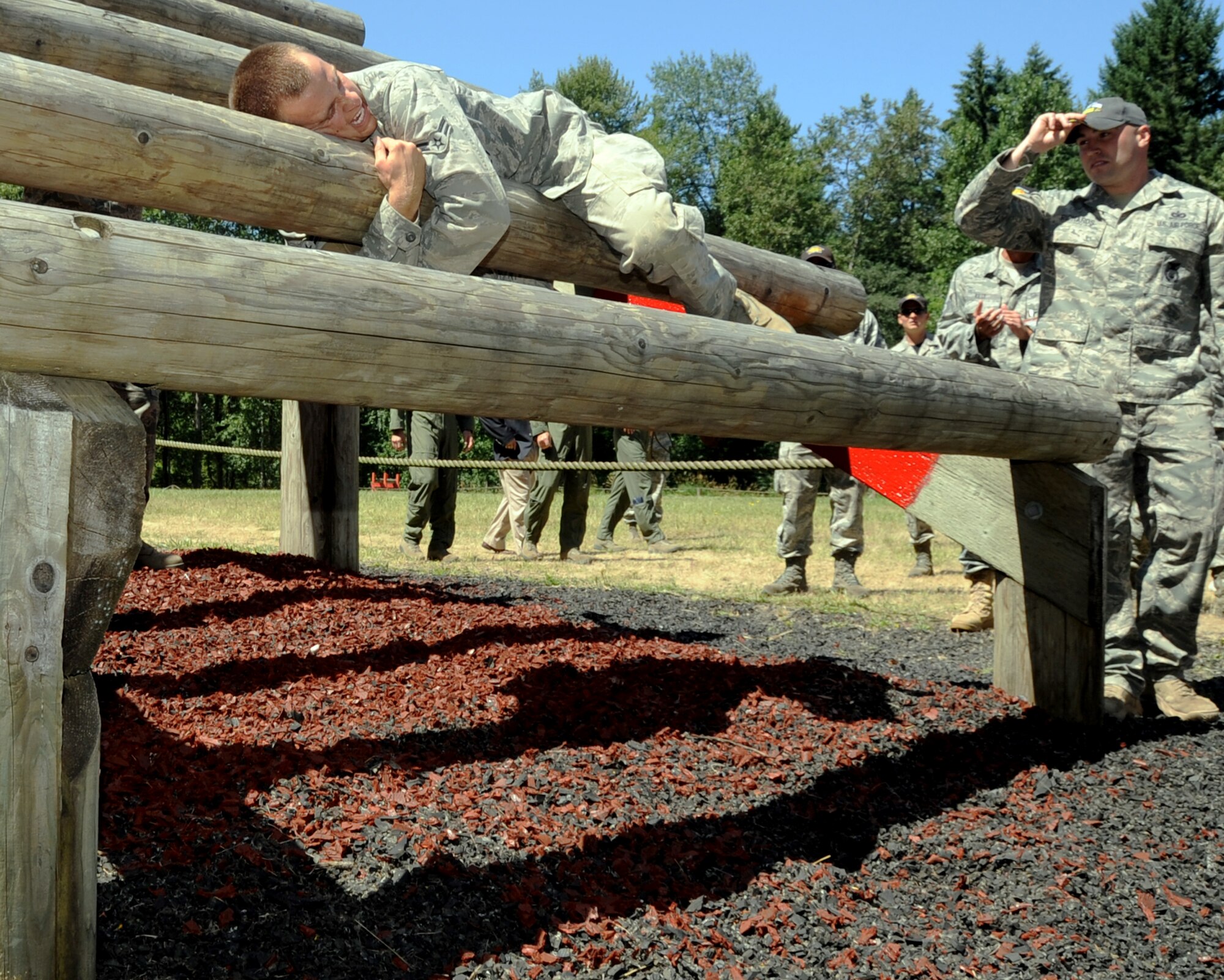 JOINT BASE LEWIS-MCCHORD, Wash. -- Airman 1st Class Eric Newland, 97th Security Forces Squadron Rodeo Team member from Altus Air Force Base, Okla., climbs the last part of a weaver obstacle during the 2011 Air Mobility Command Rodeo Combat Endurance Competition July 28. The CEC included 18 obstacles, four Combat Skills, a 1.2 mile run that tested the team on physical conditioning and field craft skills. (U.S. Air Force photo by Airman 1st Class Kenneth W. Norman / Released / 97th Air Mobility Wing Rode Public Affairs)  
