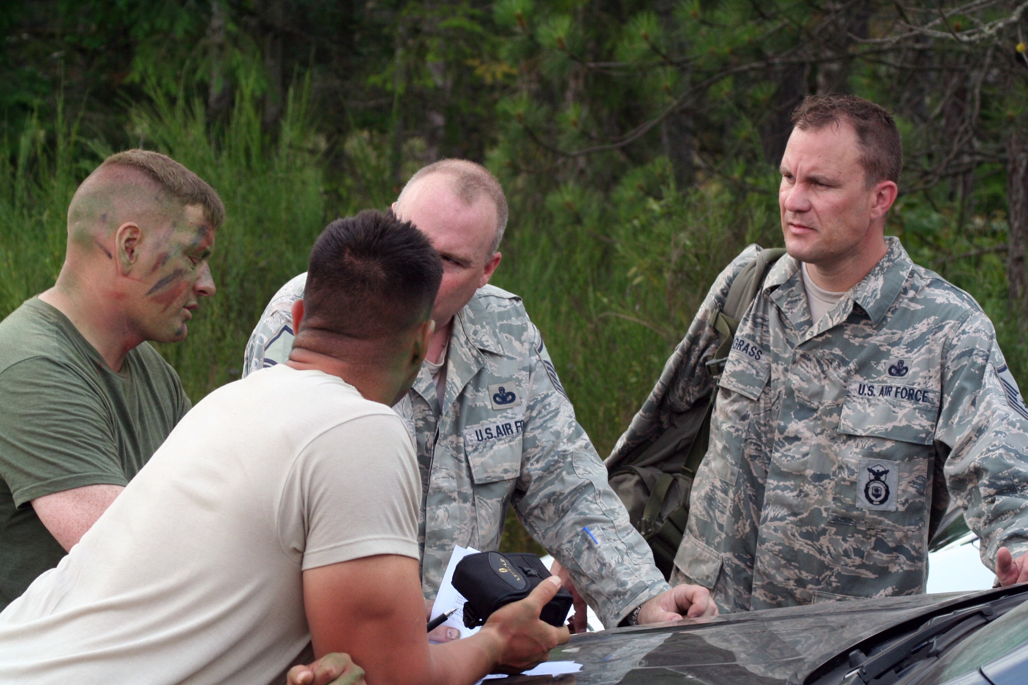 Senior Master Sgt. Nathan Brett and Staff Sgt. George Reinas (left), both sniper-qualified Airmen in the Air Force, provide feedback to an advanced marksmanship team on a range on Joint Base Lewis-McChord, Wash., on July 27, 2011. Brett and Reinas were the event coordinators for the advanced marksmanship event for Air Mobility Rodeo 2011 at Joint Base Lewis-McChord. Brett is the superintendent of the U.S. Air Force Expeditionary Center's 421st Combat Training Squadron at Joint Base McGuire-Dix-Lakehurst, N.J., and Reinas is a security forces combat skill instructor in the 421st CTS. (U.S. Air Force Photo/Master Sgt. Scott T. Sturkol)