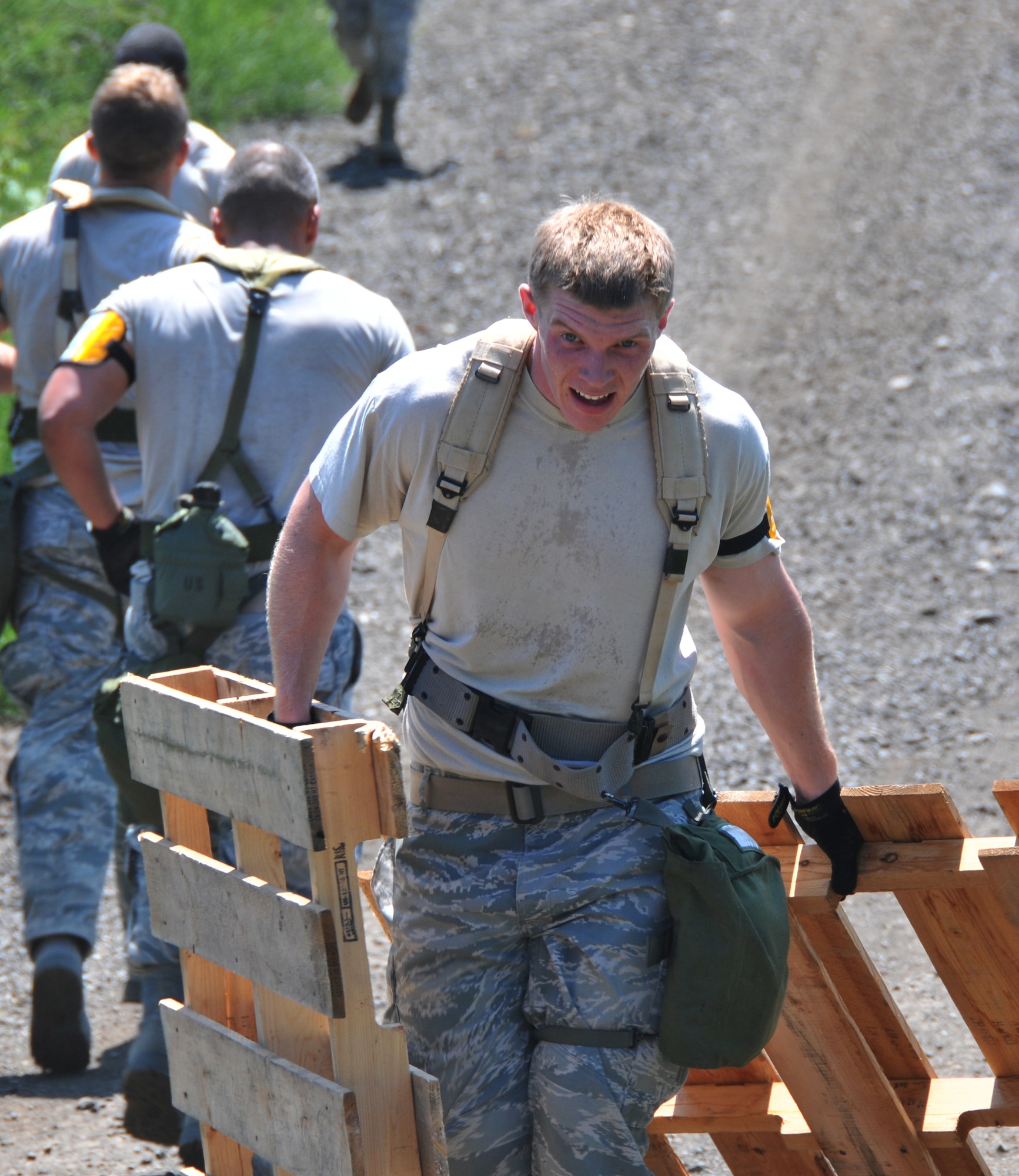 An Airman drags two wooden pallets, July 28, 2011 at Joint Base Lewis-McChord, Wash., during an aerial port obstacle course. The event was part of Air Mobility Rodeo 2011, a biennial international competition that focuses on mission readiness, featuring airdrops, aerial refueling and other events that showcase the skills of mobility crews from around the world. (U.S. Air Force photo/Airman 1st Class Jared Trimarchi) 
 