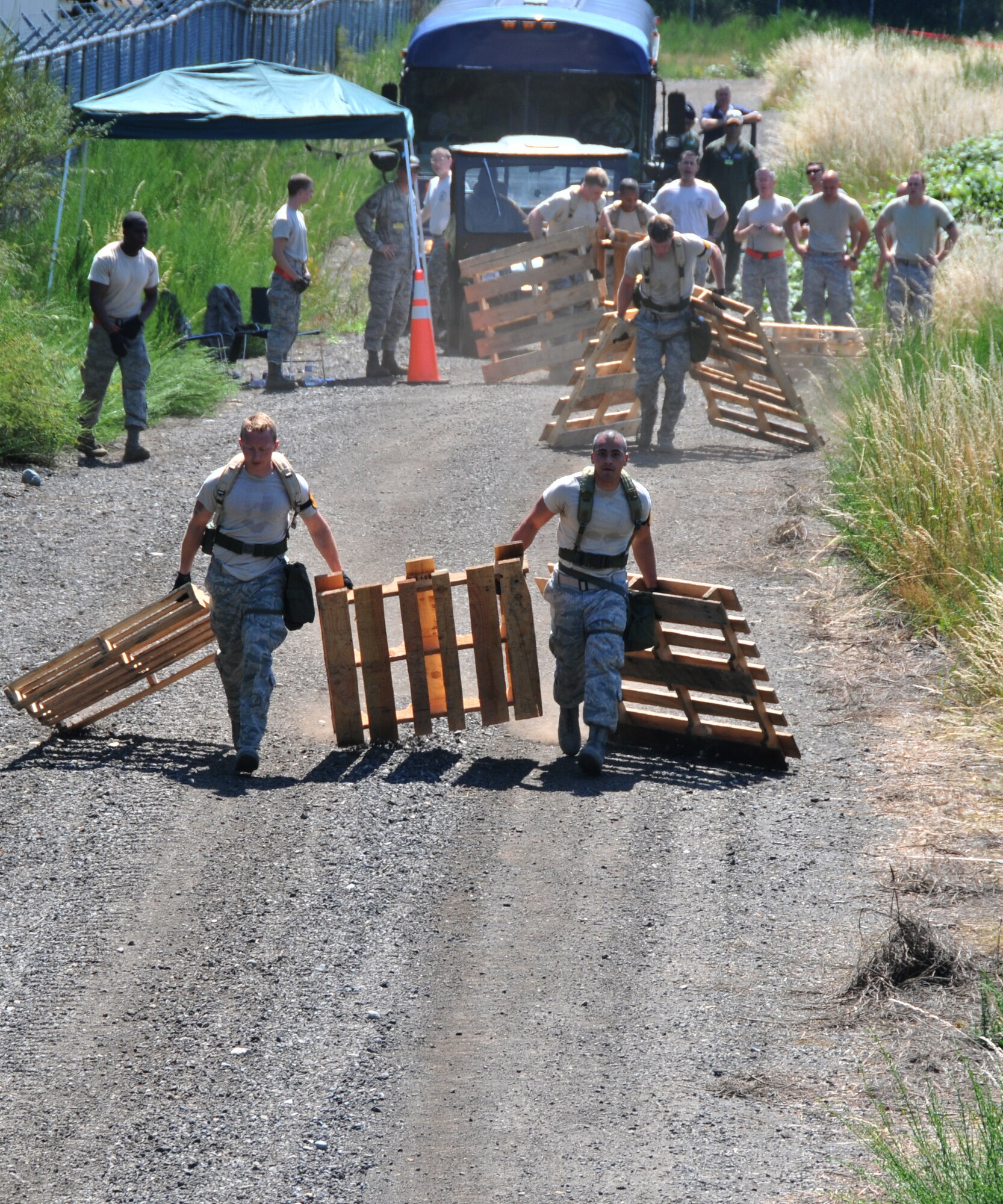 Airmen move wooden pallets, July 28, 2011 at Joint Base Lewis-McChord, Wash., during an aerial port obstacle course. The event was part of Air Mobility Rodeo 2011, a biennial international competition that focuses on mission readiness, featuring airdrops, aerial refueling and other events that showcase the skills of mobility crews from around the world. (U.S. Air Force photo/Airman 1st Class Jared Trimarchi) 
