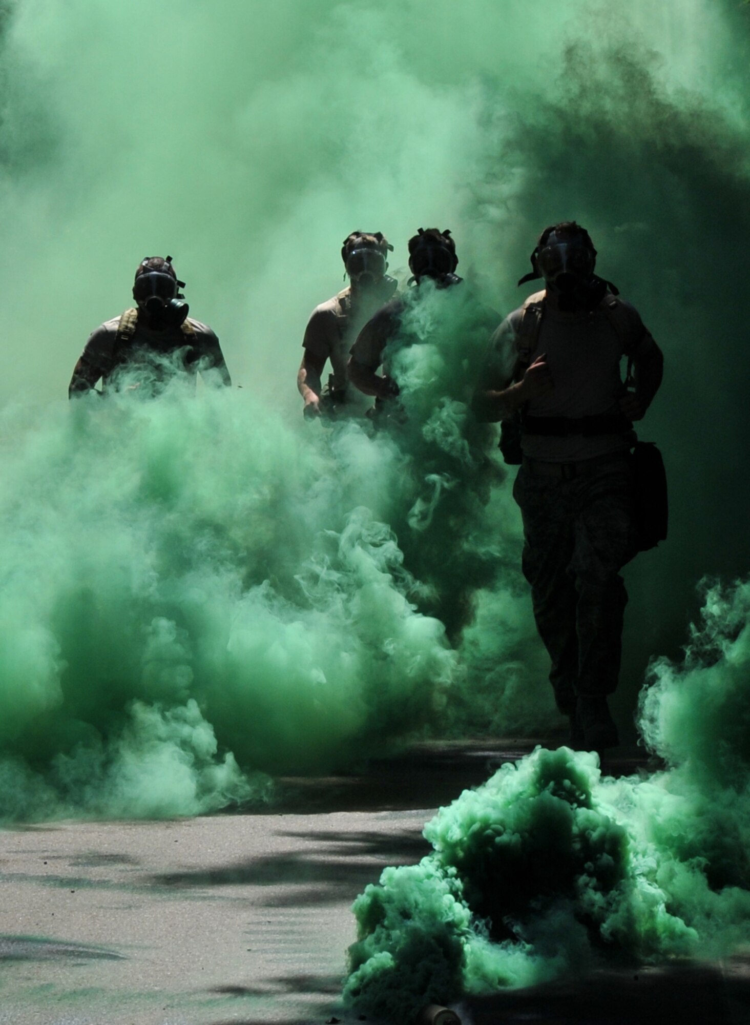 Airmen run through smoke, July 28, 2011 at Joint Base Lewis-McChord, Wash., during an aerial port obstacle course. The event was part of Air Mobility Rodeo 2011, a biennial international competition that focuses on mission readiness, featuring airdrops, aerial refueling and other events that showcase the skills of mobility crews from around the world. (U.S. Air Force photo/Airman 1st Class Jared Trimarchi) 
