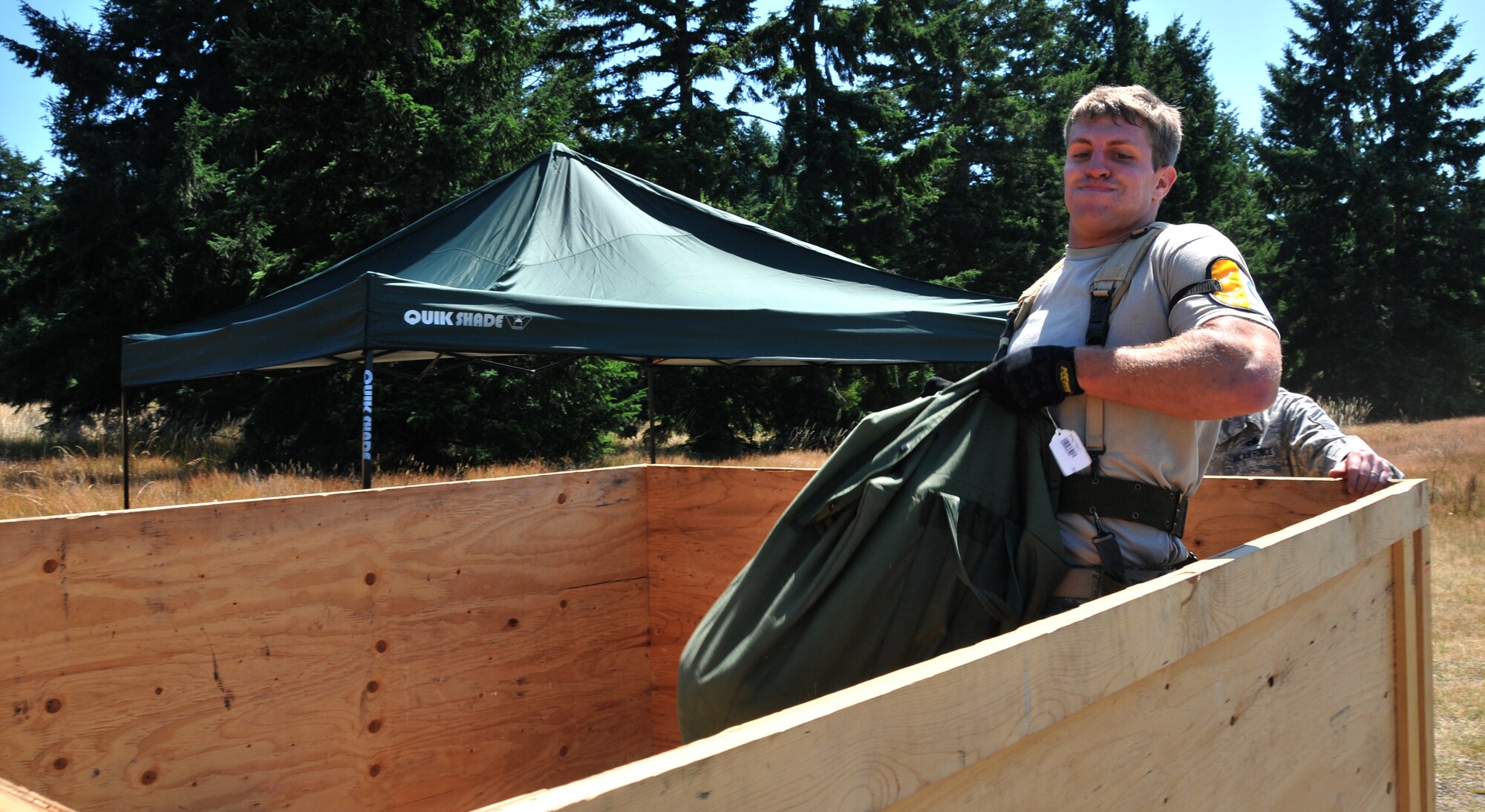 An Airman lifts a sandbag July 28, 2011 at Joint Base Lewis-McChord, Wash., during an aerial port obstacle course. The event was part of Air Mobility Rodeo 2011, a biennial international competition that focuses on mission readiness, featuring airdrops, aerial refueling and other events that showcase the skills of mobility crews from around the world. (U.S. Air Force photo/Airman 1st Class Jared Trimarchi) 
