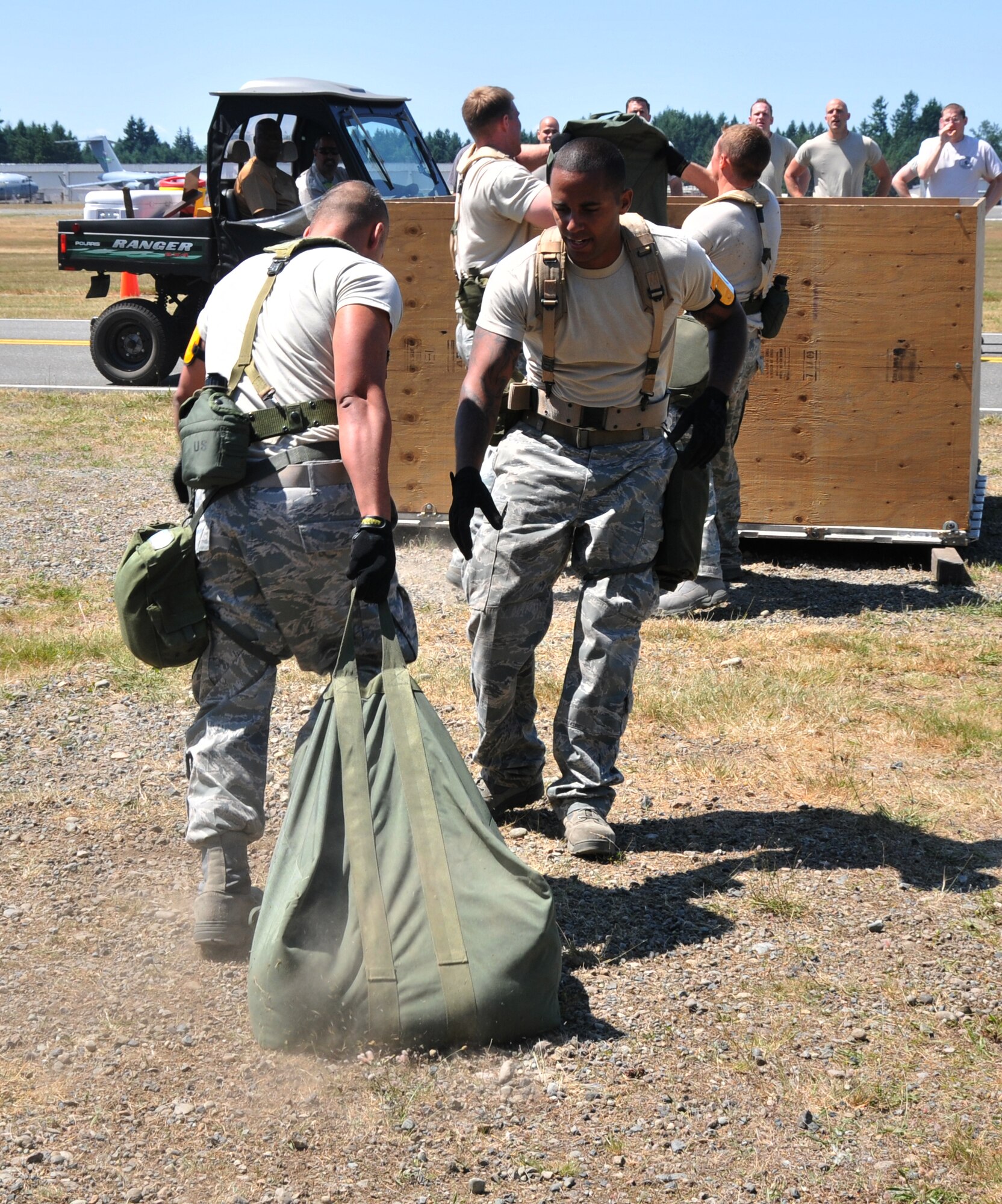 Airmen move sandbags from one pallet to the next, July 28, 2011 at Joint Base Lewis-McChord, Wash., during an aerial port obstacle course. The event was part of Air Mobility Rodeo 2011, a biennial international competition that focuses on mission readiness, featuring airdrops, aerial refueling and other events that showcase the skills of mobility crews from around the world. (U.S. Air Force photo/Airman 1st Class Jared Trimarchi) 
