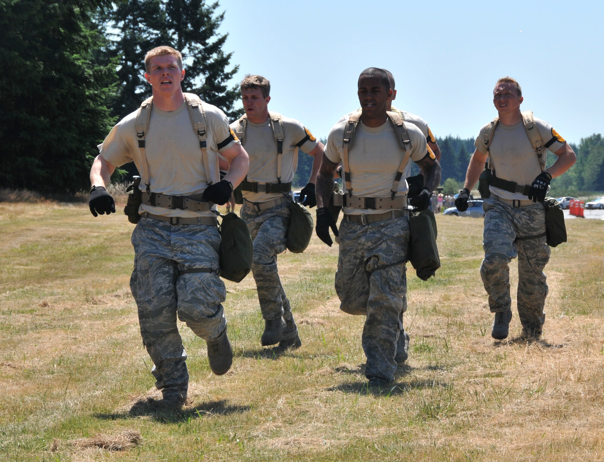 Airmen begin their run to the first challenge, July 28, 2011 at Joint Base Lewis-McChord, Wash., during an aerial port obstacle course. The event was part of Air Mobility Rodeo 2011, a biennial international competition that focuses on mission readiness, featuring airdrops, aerial refueling and other events that showcase the skills of mobility crews from around the world. (U.S. Air Force photo/Airman 1st Class Jared Trimarchi) 