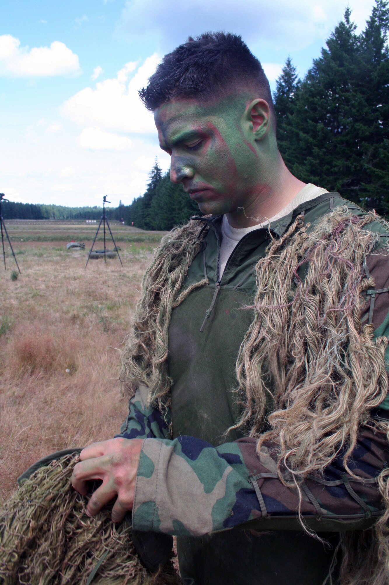 Staff Sgt. George Reinas, a sniper-qualified Airman in the Air Force, prepares for a scenario on a range on Joint Base Lewis-McChord, Wash., on July 27, 2011. Reinas was one of the event coordinators for the advanced marksmanship event for Air Mobility Rodeo 2011 at Joint Base Lewis-McChord. Reinas is a security forces combat skill instructor in the U.S. Air Force Expeditionary Center's 421st Combat Training Squadron at Joint Base McGuire-Dix-Lakehurst, N.J. (U.S. Air Force Photo/Master Sgt. Scott T. Sturkol)