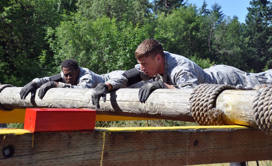 Team members of Yokota Air Base, participate in the log roll challenge during the Security Forces combat endurance course at the Air Mobility Rodeo 2011 July 28, 2011 at Joint Base Lewis-McChord, Wash. (U.S. Air Force photo/Airman 1st Class Michael Battles)