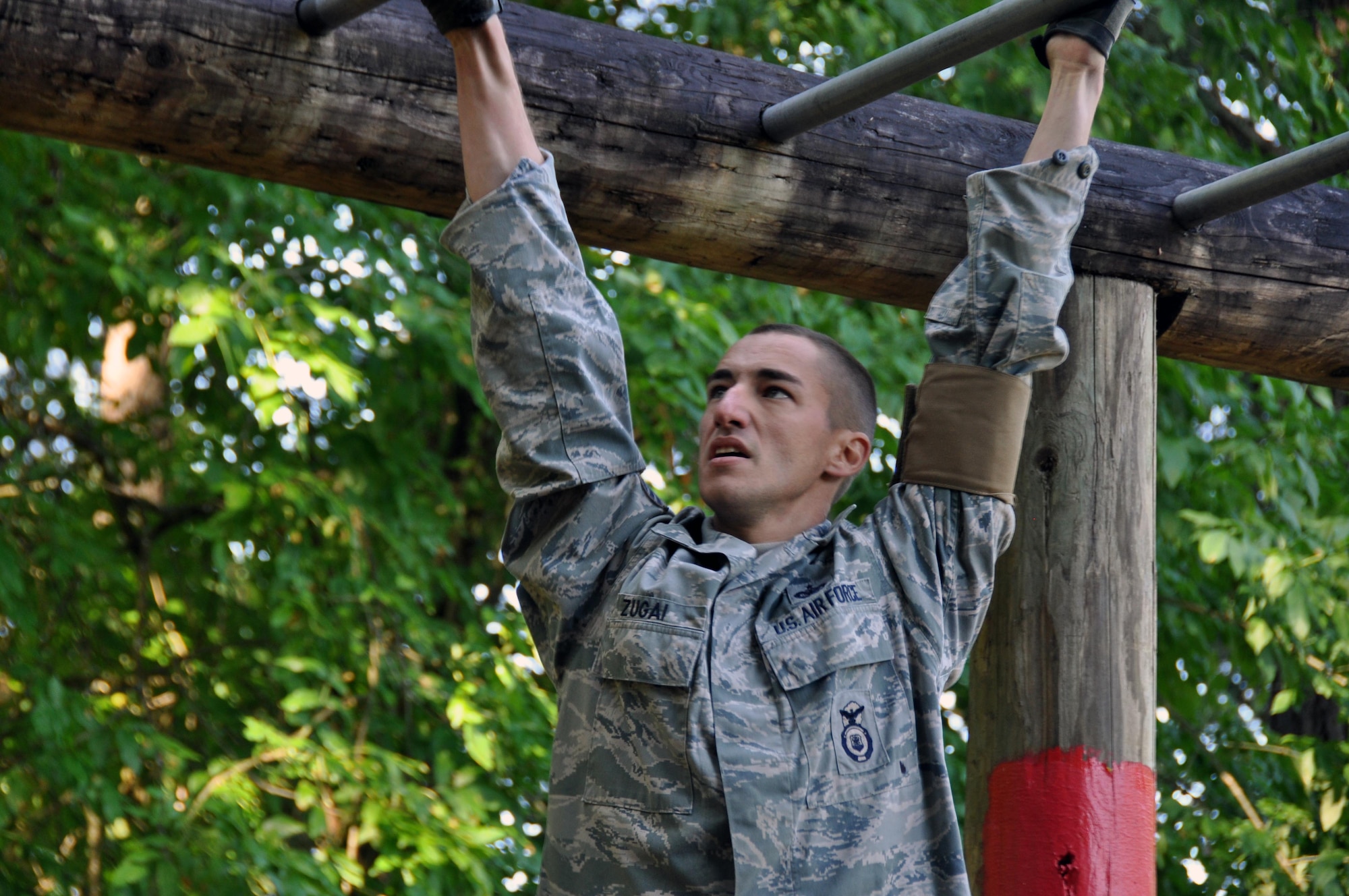 Staff Sgt. Zugai, 317th Airlift Group, participate in the monkey bar challenge during the Security Forces combat endurance course at the Air Mobility Rodeo 2011 July 28, 2011 at Joint Base Lewis-McChord, Wash. (U.S. Air Force photo/Airman 1st Class Michael Battles)