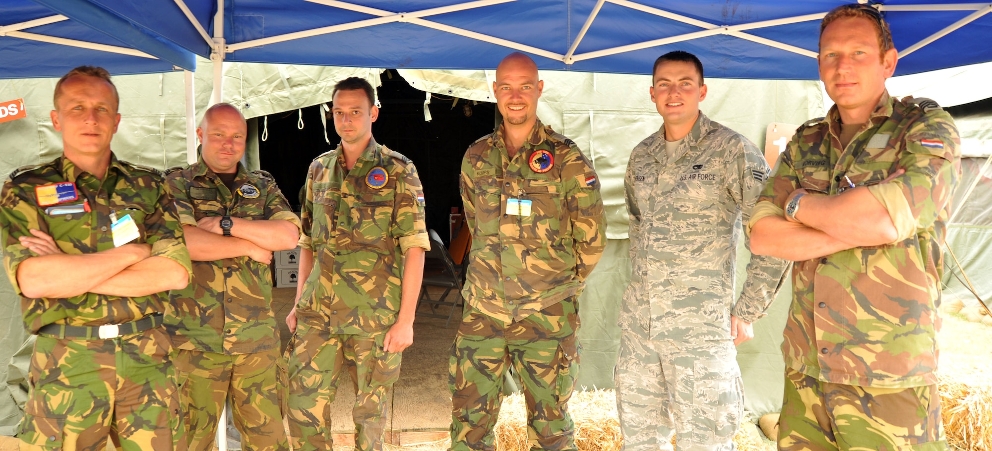 Members of the Royal Netherlands Air Force pose with Senior Airman Martin Jenson, 62nd Maintenance Squadron aerospace ground equipment mechanic July 27, 2011, at Joint Base Lewis-McChord, Wash.  Jenson was selected to be the liaison for the Dutch team during Air Mobility Rodeo 2011.  (U.S. Air Force photo/Senior Airman Abigail Klein)