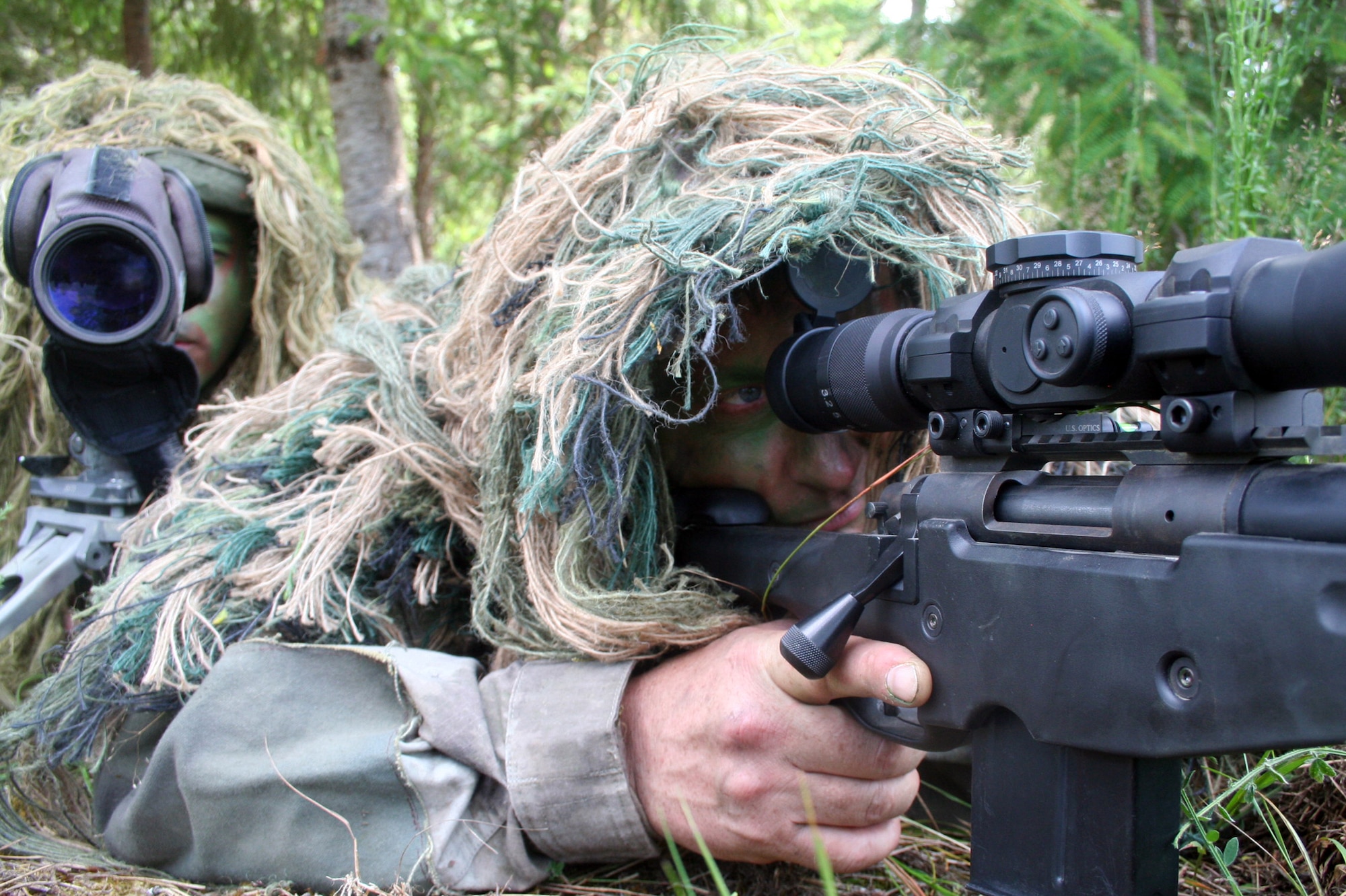 Staff Sgt. George Reinas and Senior Master Sgt. Nathan Brett, both sniper-qualified Airmen in the Air Force, practice a scenario on a range on Joint Base Lewis-McChord, Wash., on July 27, 2011. Brett and Reinas were the event coordinators for the advanced marksmanship event for Air Mobility Rodeo 2011 at Joint Base Lewis-McChord. Brett is the superintendent of the U.S. Air Force Expeditionary Center's 421st Combat Training Squadron at Joint Base McGuire-Dix-Lakehurst, N.J., and Reinas is a security forces combat skill instructor in the 421st CTS. (U.S. Air Force Photo/Master Sgt. Scott T. Sturkol)