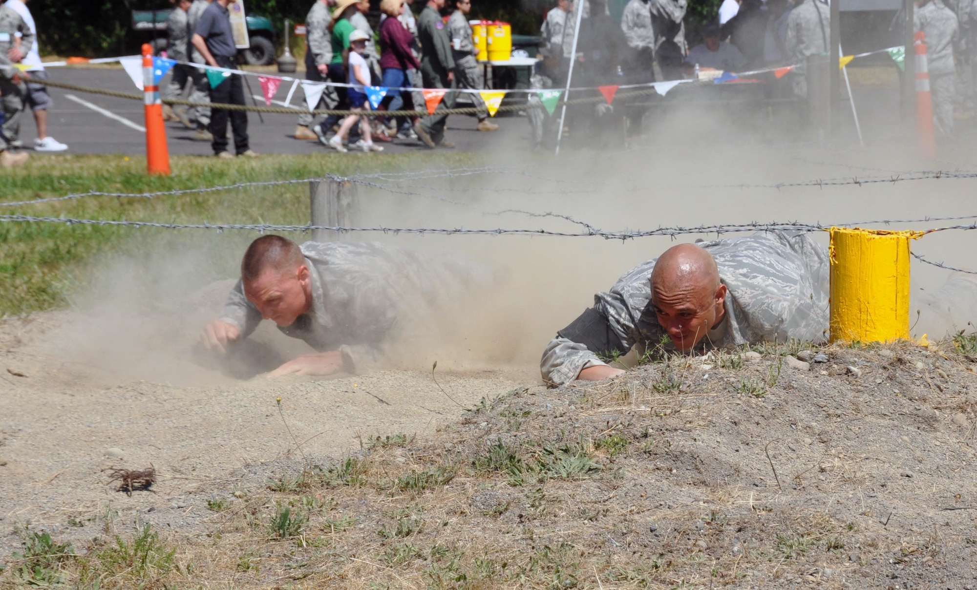 Staff Sgt. Jade Mcleod and Staff Sgt, Cedric Hollman,60th Air Mobility Wing, participate in the initial low crawl challenge during the Security Forces combat endurance course at the Air Mobility Rodeo 2011 July 28, 2011 at Joint Base Lewis-McChord, Wash. (U.S. Air Force photo/Airman 1st Class Michael Battles)