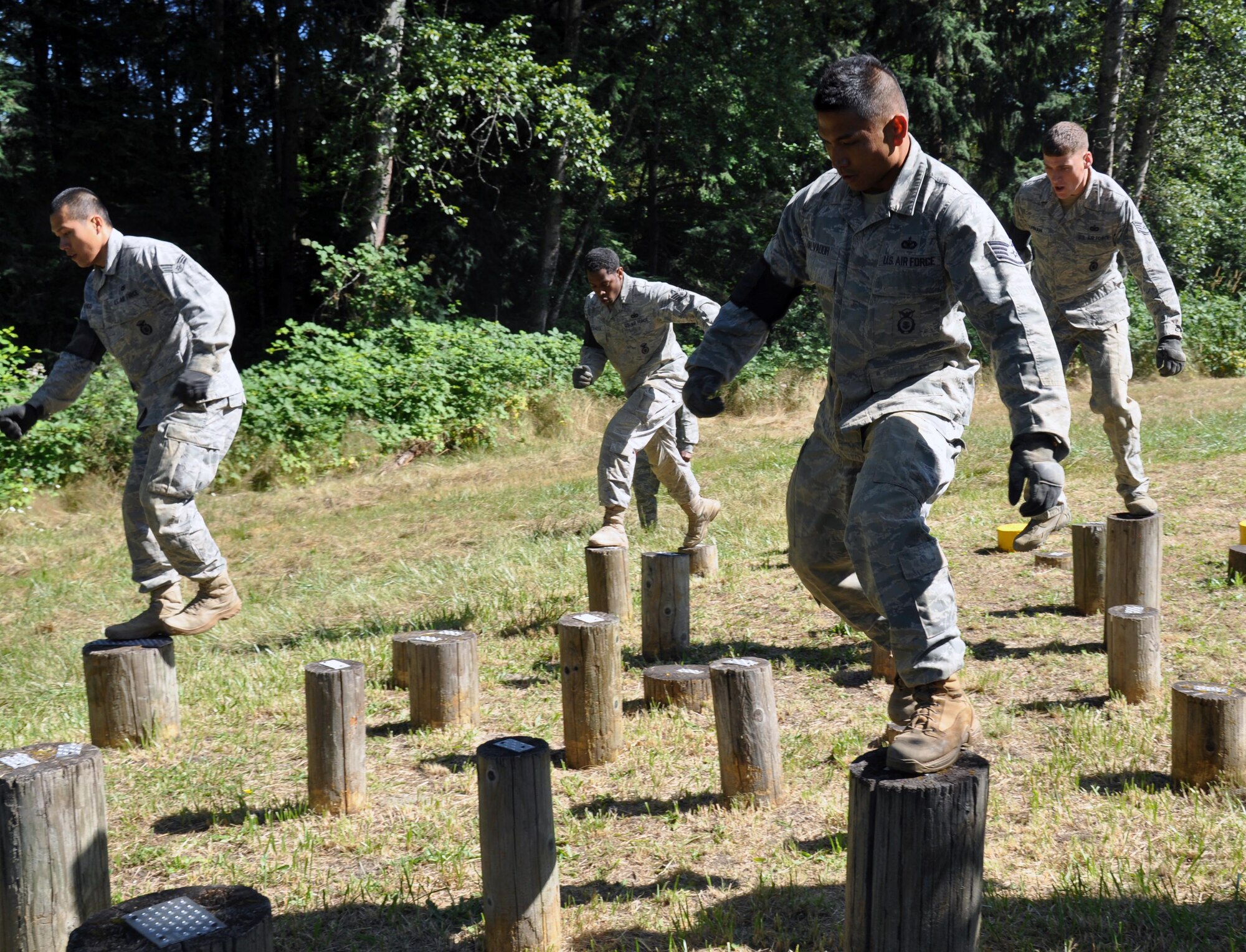 Team members from Yokota Air Base, participates in the log roll challenge during the Security Forces combat endurance course at the Air Mobility Rodeo 2011 July 28, 2011 at Joint Base Lewis-McChord, Wash. (U.S. Air Force photo/Airman 1st Class Michael Battles)