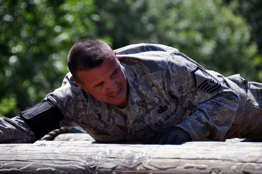 Master Sgt. Sean Burke, 436th Airlift Wing, participates in the log roll challenge during the Security Forces combat endurance course at the Air Mobility Rodeo 2011 July 28, 2011 at Joint Base Lewis-McChord, Wash. (U.S. Air Force photo/Airman 1st Class Michael Battles)