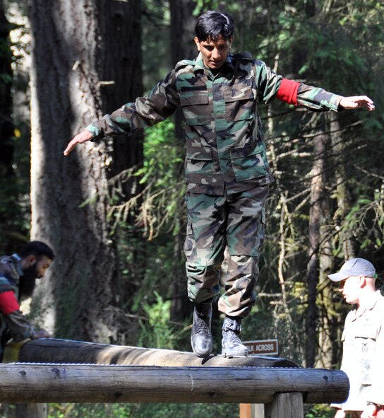 Sqnldr Naeey,Pakistan air force, participates in the balance beam challenge during the Security Forces combat endurance course at the Air Mobility Rodeo 2011 July 28, 2011 at Joint Base Lewis-McChord, Wash. (U.S. Air Force photo/Airman 1st Class Michael Battles)