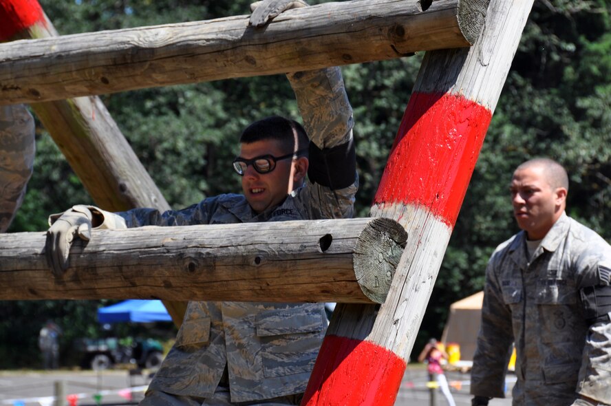 Staff Sgt. Mark Devine, 512th Airlift Wing, participates in the over wall challenge during the Security Forces combat endurance course at the Air Mobility Rodeo 2011 July 28, 2011 at Joint Base Lewis-McChord, Wash. (U.S. Air Force photo/Airman 1st Class Michael Battles)