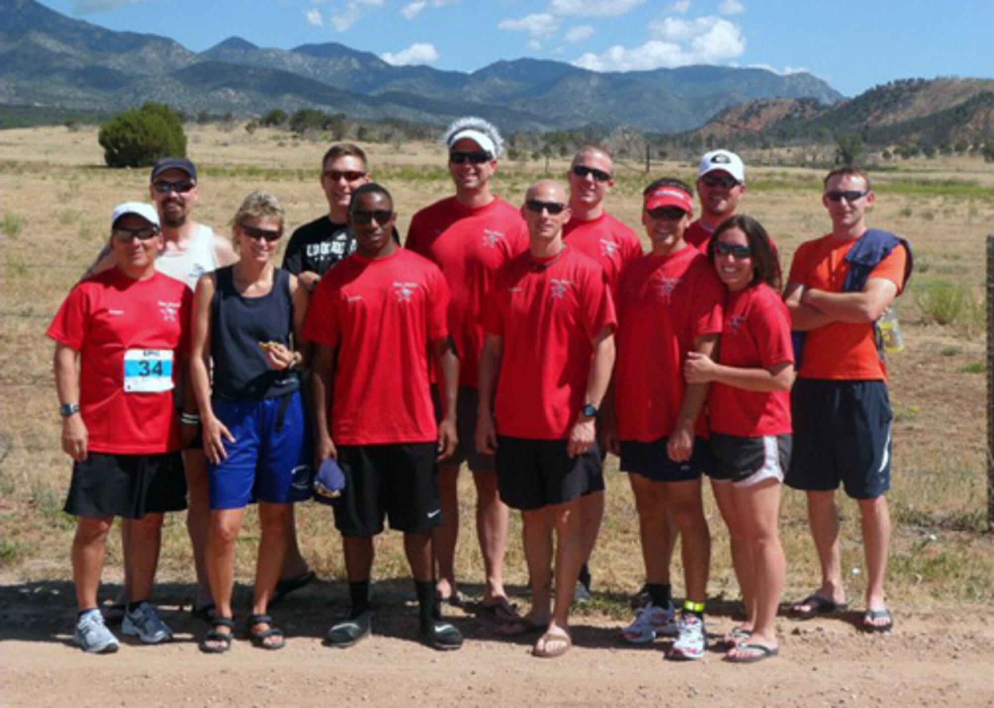 COLORADO SPRINGS, Colo. -- Team "Red Storm" from Schriever Air Force Base, Colo., gets ready to run a 200-mile relay race July 22. Front Row (left to right) Ken Trousdale, Tami Wise, Kendeldrick Broaden, Matthew Mancuso, Andy Shawver and Vanessa Warren. Back Row (left to right) Jon Davis, Adam Fisher, Dean Sniegowski, Dave Gapper, Rob Wilson and Chris Crump. (Photo courtesy of 26th Space Aggressor Squadron)