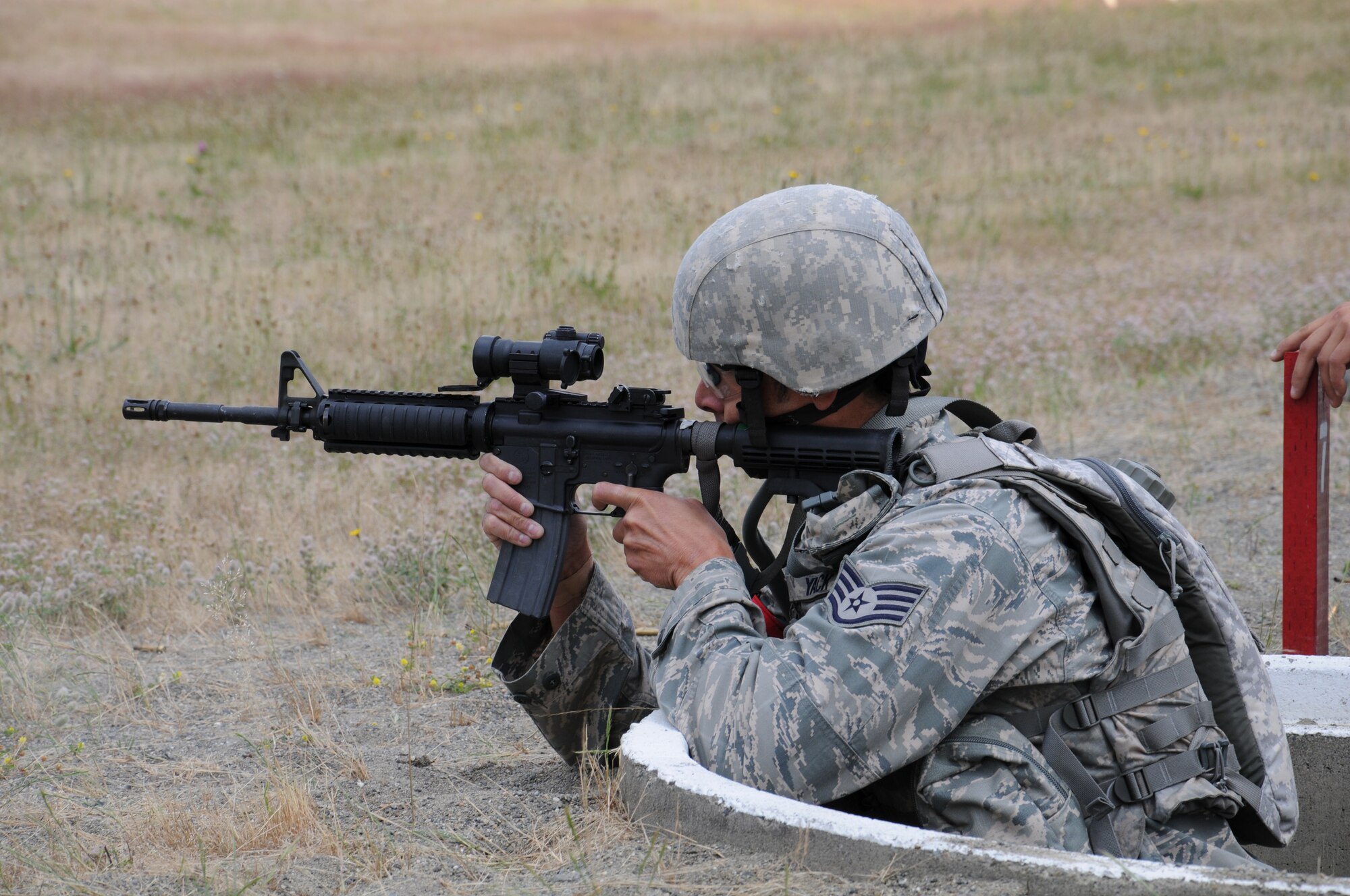 Staff Sgt. David Buchanon, safety manager with the 446th Security Forces Squadron, fires at moving targets with an M-16 during the Combat Weapons competition for Rodeo on Wednesday at the firing range at Joint Base Lewis McChord-Lewis Main. For his civilian job, Buchanan works in reports and analysis at the Doctorate of Emergency Services on Lewis Main. (U.S. Air Force photo by 2nd Lt. Denise Hauser)