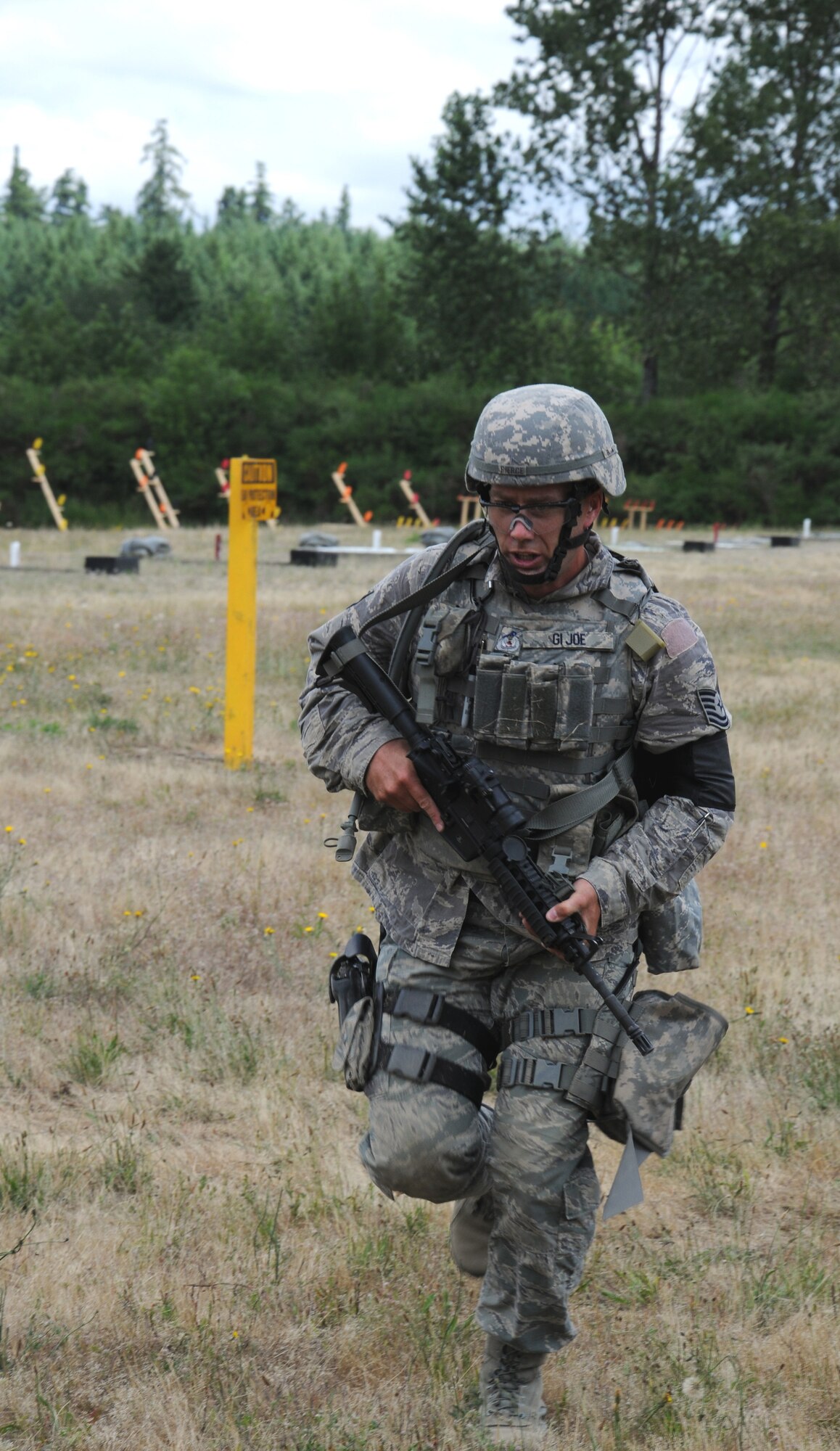 Tech. Sgt. Christopher Pierce, a patrolman with the 446th Security Forces Squadron, sprints to his position during the Combat Weapons competition for Rodeo on Wednesday at the firing range at Joint Base Lewis McChord-Lewis Main.  Pierce is a security officer for The Boeing Company in his civilian career.  (U.S. Air Force photo by 2nd Lt. Denise Hauser)