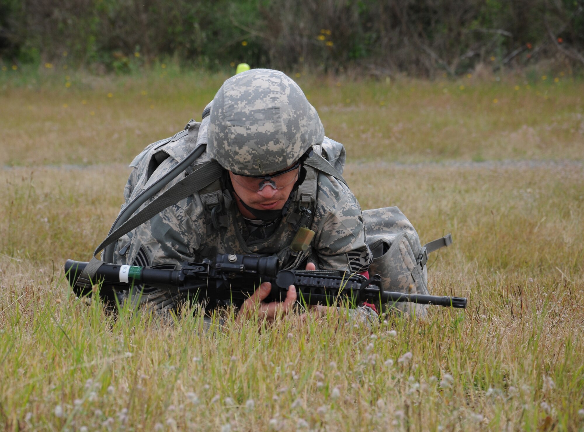 Tech. Sgt. Jack Montez, training manager for the 446th Security Forces Squadron, low crawls back to his firing position as part of the Combat Weapons portion of the Rodeo competition Wednesday at the firing range at Joint Base Lewis McChord-Lewis Main.  Montez is a full-time Reservist with the 446th AW. (U.S. Air Force photo by 2nd Lt. Denise Hauser)