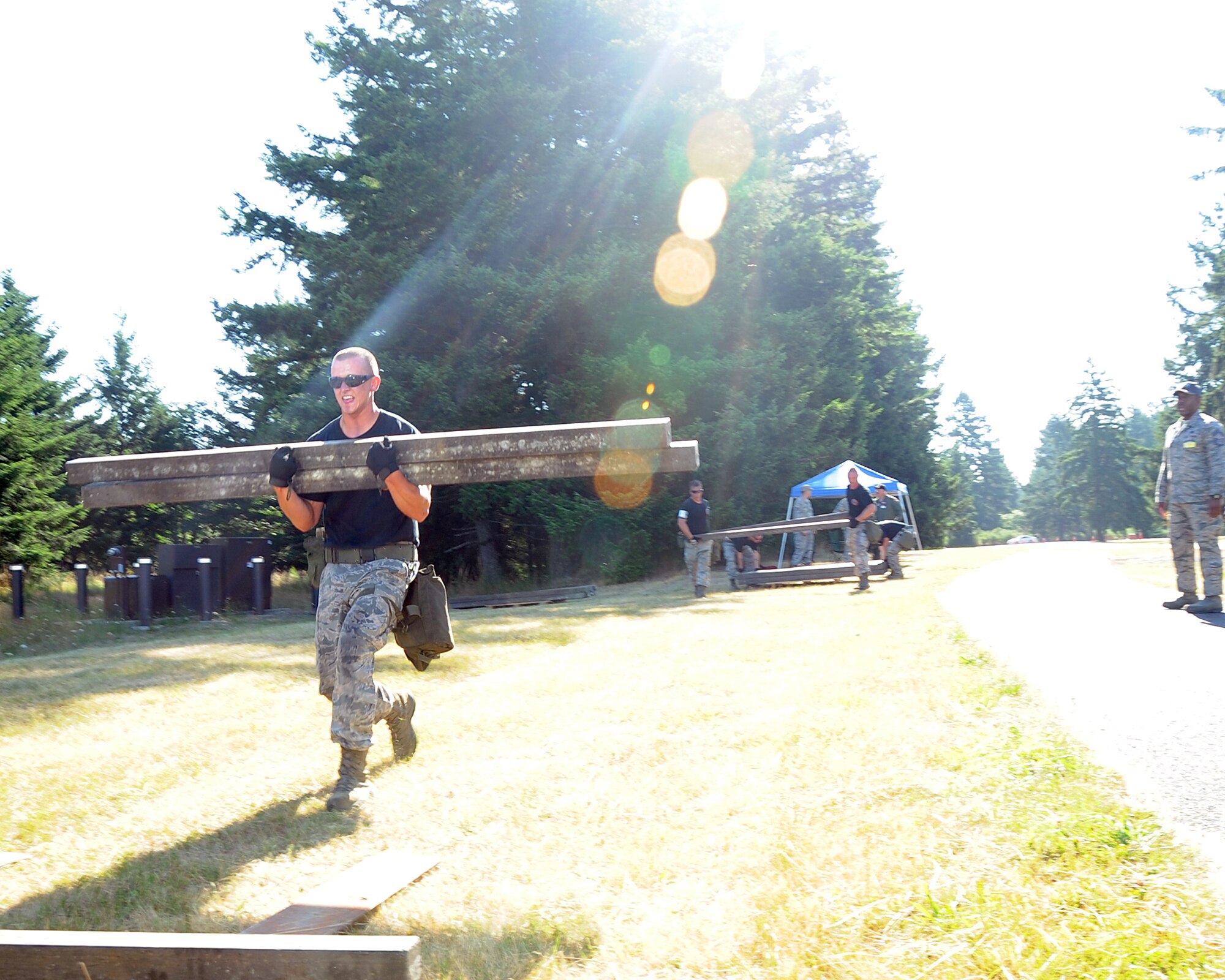 JOINT BASE LEWIS-MCCHORD, Wash. – Airman 1st Class Joshua Verran, 97th Logistics Readiness Squadron Rodeo Team member from Altus Air Force Base, Okla., carries palette shoring from one location to a second station at a physical challenge station as part of the 2011 Air Mobility Command Rodeo Challenge Course July 28, 2011. During the Challenge Course, the five-man team from 97th LRS ran a 3.6 mile, 14-obstacle course that challenged their physical ability and team work. (U.S. Air Force photo by Airman 1st Class Kenneth W. Norman / Released / 97th Air Mobility Wing Rode Public Affairs)