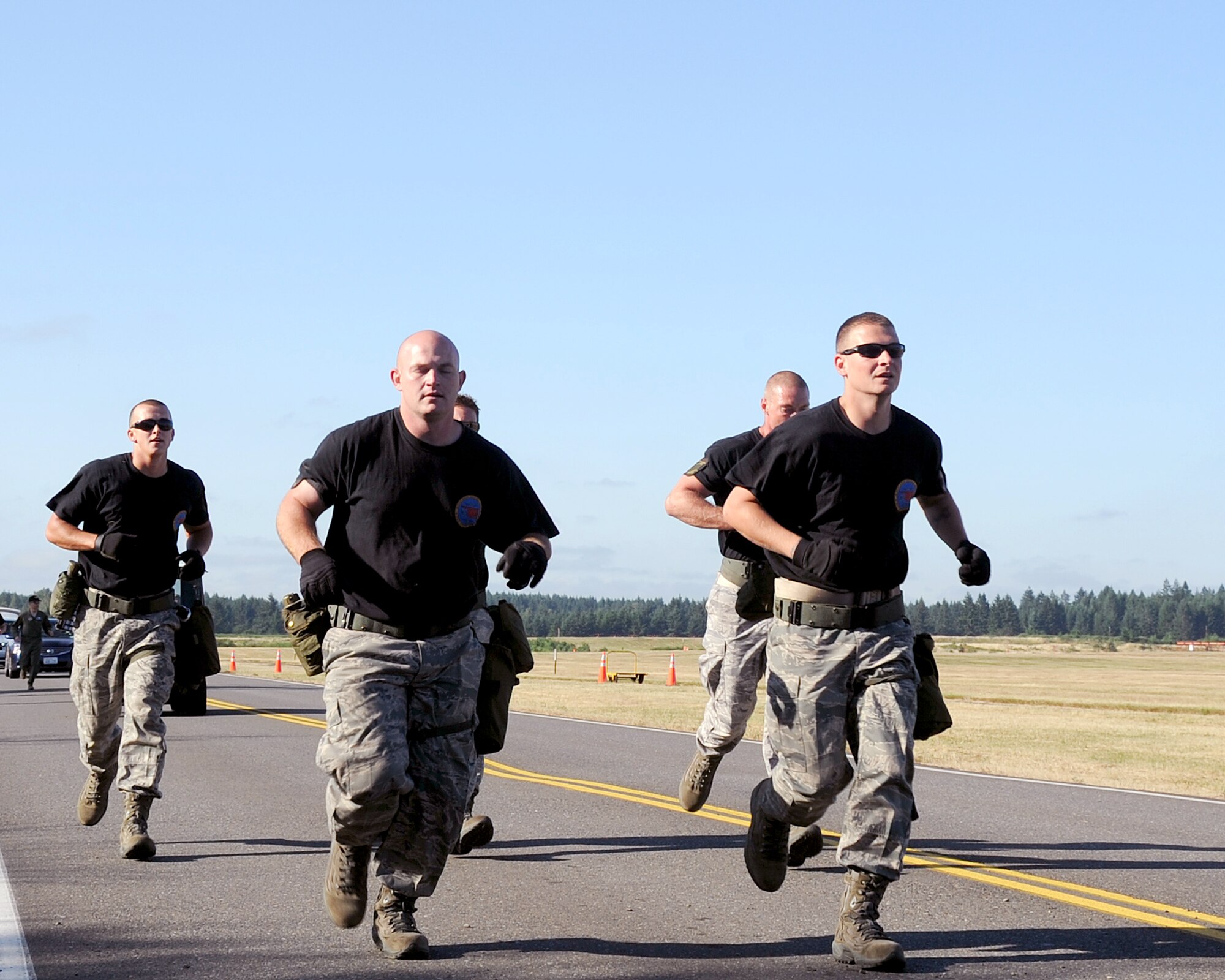 JOINT BASE LEWIS-MCCHORD, Wash. – The 97th Logistics Readiness Squadron Rodeo Team from Altus Air Force Base, Okla., runs to the next obstacle during the 2011 Air Mobility Command Rodeo Challenge Course July 28, 2011. During the Challenge Course, the five-man team from 97th LRS ran a 3.6 mile, 14-obstacle course that challenged their physical ability and team work. (U.S. Air Force photo by Airman 1st Class Kenneth W. Norman / Released / 97th Air Mobility Wing Rode Public Affairs)