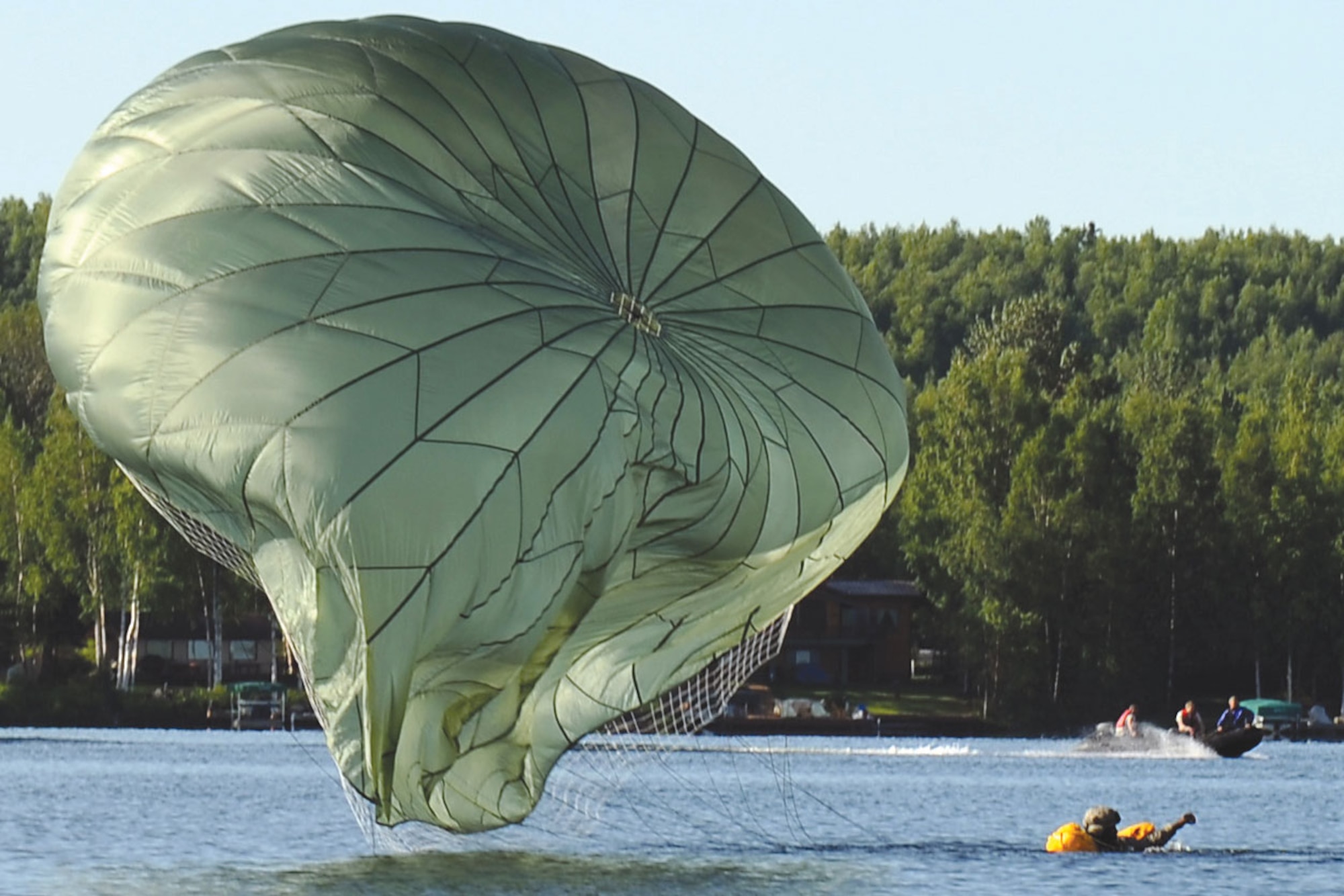 A 1st Battalion (Airborne) 501st Infantry Regiment paratrooper waits for pickup during a water landing exercise at Big Lake, July 22. (U.S. Air Force photo/Justin Connaher)