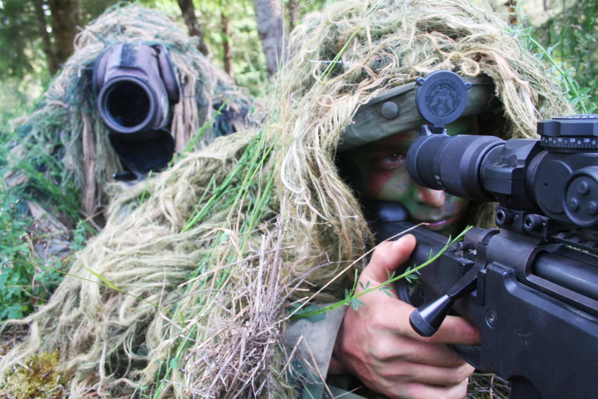 Senior Master Sgt. Nathan Brett and Staff Sgt. George Reinas, both sniper-qualified Airmen in the Air Force, practice a scenario on a range on Joint Base Lewis-McChord, Wash., on July 27, 2011. Brett and Reinas were the event coordinators for the advanced marksmanship event for Air Mobility Rodeo 2011 at Joint Base Lewis-McChord. Brett is the superintendent of the U.S. Air Force Expeditionary Center's 421st Combat Training Squadron at Joint Base McGuire-Dix-Lakehurst, N.J., and Reinas is a security forces combat skill instructor in the 421st CTS. (U.S. Air Force Photo/Master Sgt. Scott T. Sturkol)