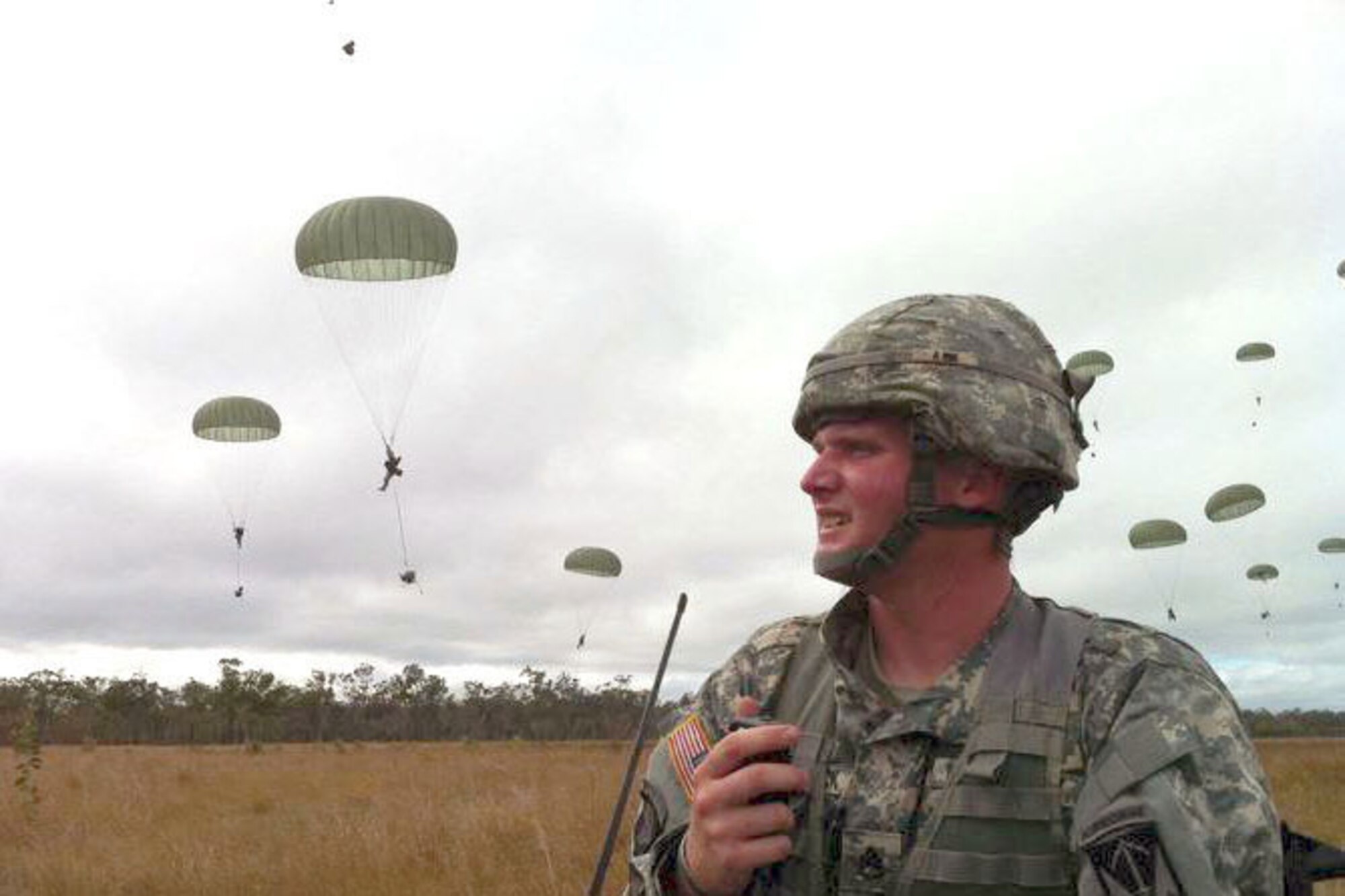 Army Staff Sgt. Bryan Comstock, 6th Engineer Battalion (Combat) (Airborne), takes accountability of paratroopers in the assembly area during an airborne assault into the Shoalwater Bay Training Area, Australia. U.S. Army Alaska Sappers took part in forced-entry training exercise with elements of the 1st Battalion, 501st Parachute Infantry Regiment, 4th Brigade Combat Team, 25th Infantry Division in Exercise Talisman Sabre 2011, biennial training involving U.S. and Australian forces. (Courtesy photo)
