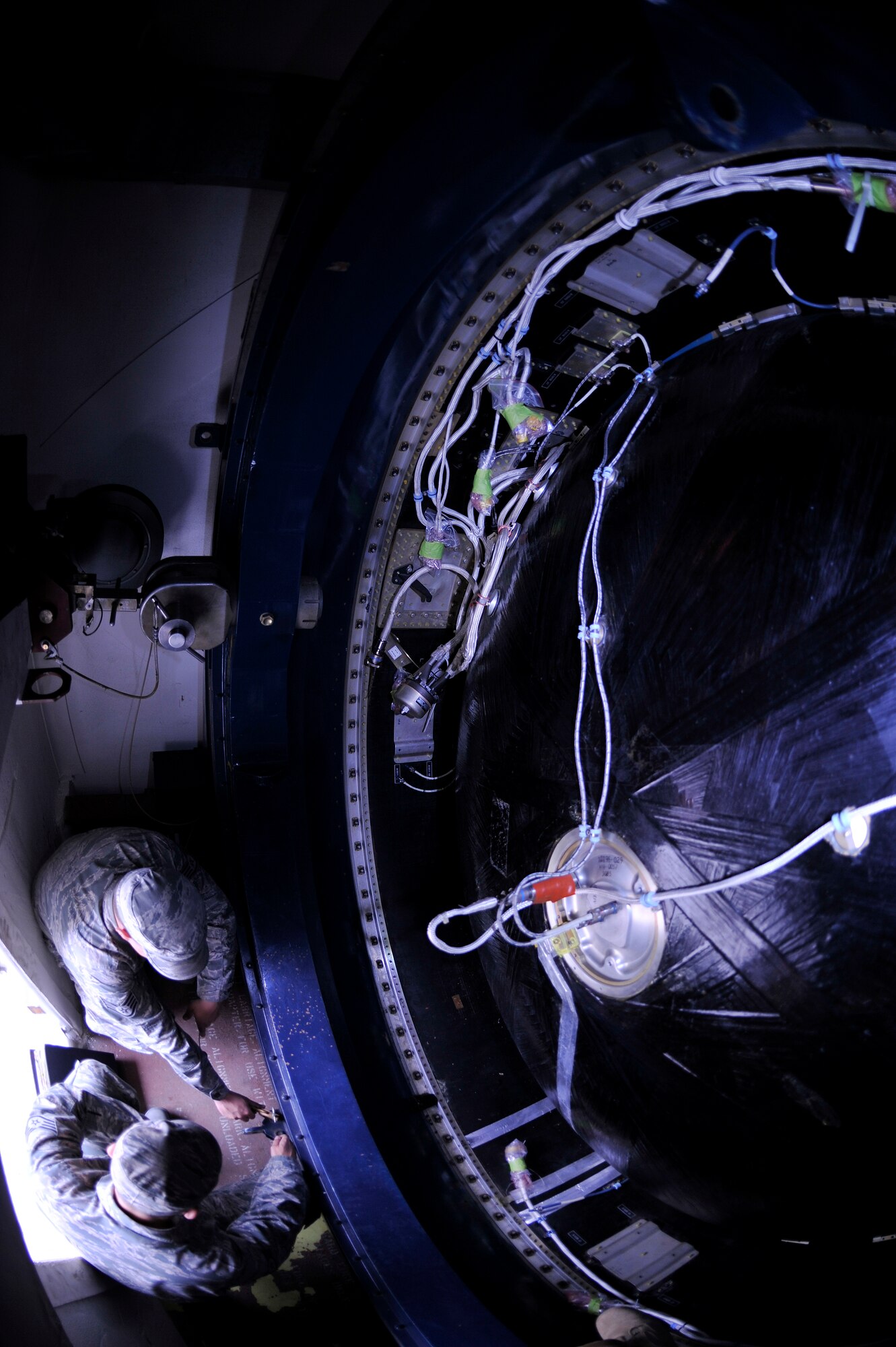 VANDENBERG AIR FORCE BASE, Calif. -- Staff Sgt. Joshua Holder and Staff Sgt. Benjamin Linenberger, 1st Air and Space Test Squadron members, ground a motor during a training session here Tuesday, July 19, 2011.  (U.S. Air Force photo/Staff Sgt. Andrew Satran) 

  