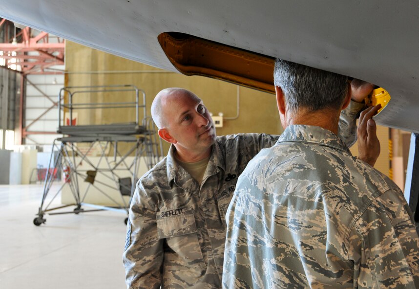 Master Sgt. Bryan Shifflett, 452nd Maintenance Squadron, shows Col . Karl McGregor, 452nd Air Mobility Wing commander, completed refurbishment work under the nose of a KC-135 Stratotanker at March Air Reserve Base, Calif., July 18, 2011. This first refurbishment took 23 working days, but the refurbishment program took nearly three years to implement. (U.S. Air Force photo/Megan Just)