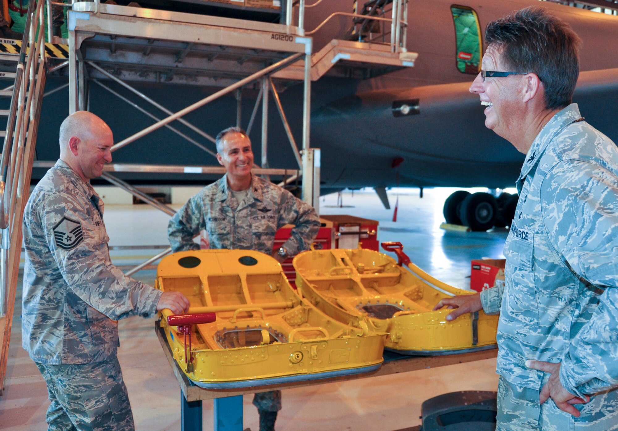 (from left) Master Sgt. Bryan Shifflett, 452nd Maintenance Squadron, Col . Karl McGregor, 452nd Air Mobility Wing commander, and Col. Robert Stormes, 452nd Maintenance Squadron, exchange a laugh during a tour of a newly refurbished KC-135 Stratotanker at March Air Reserve Base, Calif., July 18, 2011. This first refurbishment took about 25 working days, but the refurbishment program took nearly three years to implement. (U.S. Air Force photo/Megan Just)