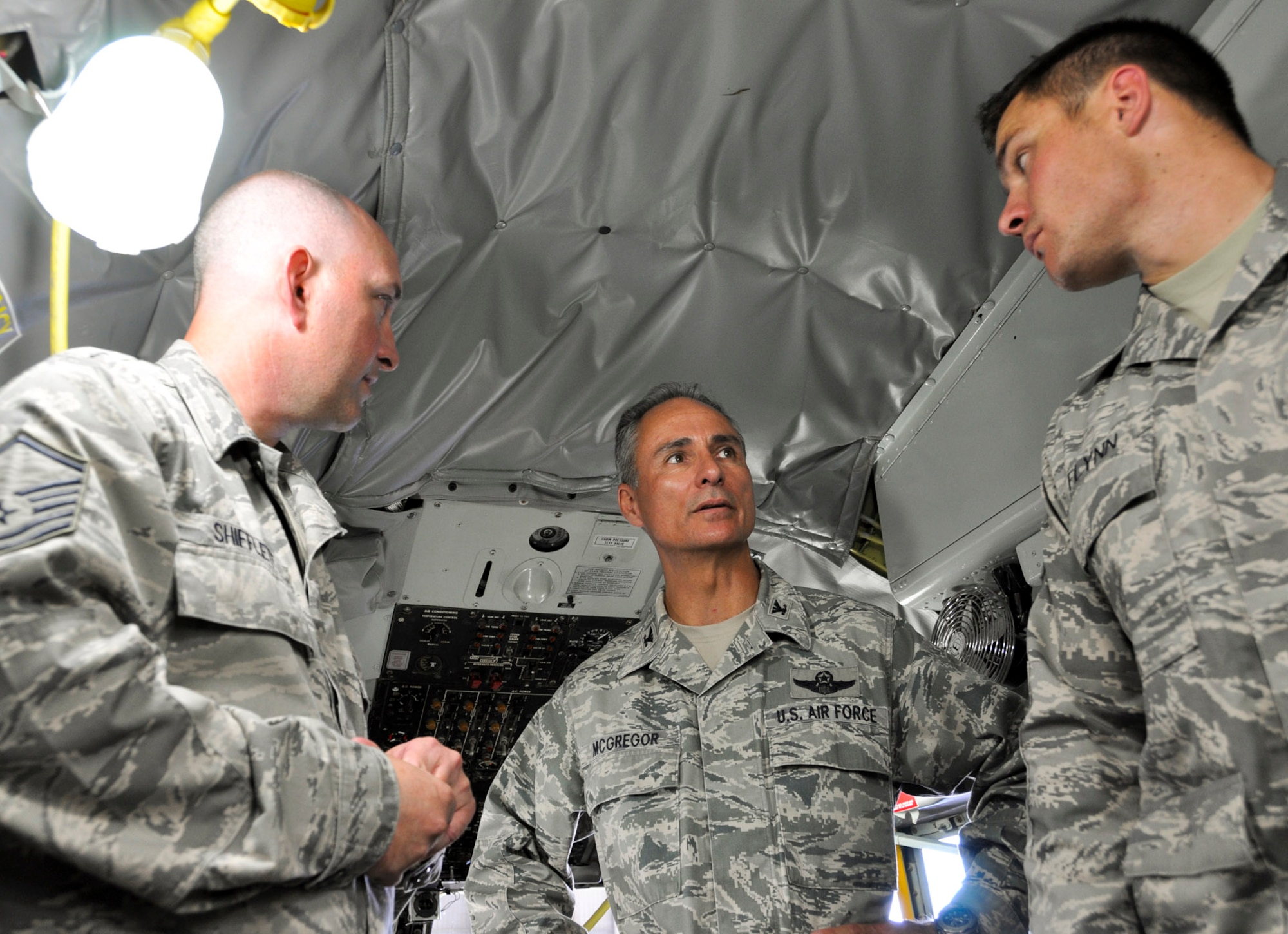 Col . Karl McGregor, 452nd Air Mobility Wing commander, talks with Master Sgt. Bryan Shifflett (left) and Staff Sgt. Jonathan Flynn in the flight cabin of a newly refurbished KC-135 Stratotanker at March Air Reserve Base, Calif., July 18, 2011. The KC-135 refurbishment program took nearly three years to implement and is the wing's first complete refurbishment. (U.S. Air Force photo/Megan Just)