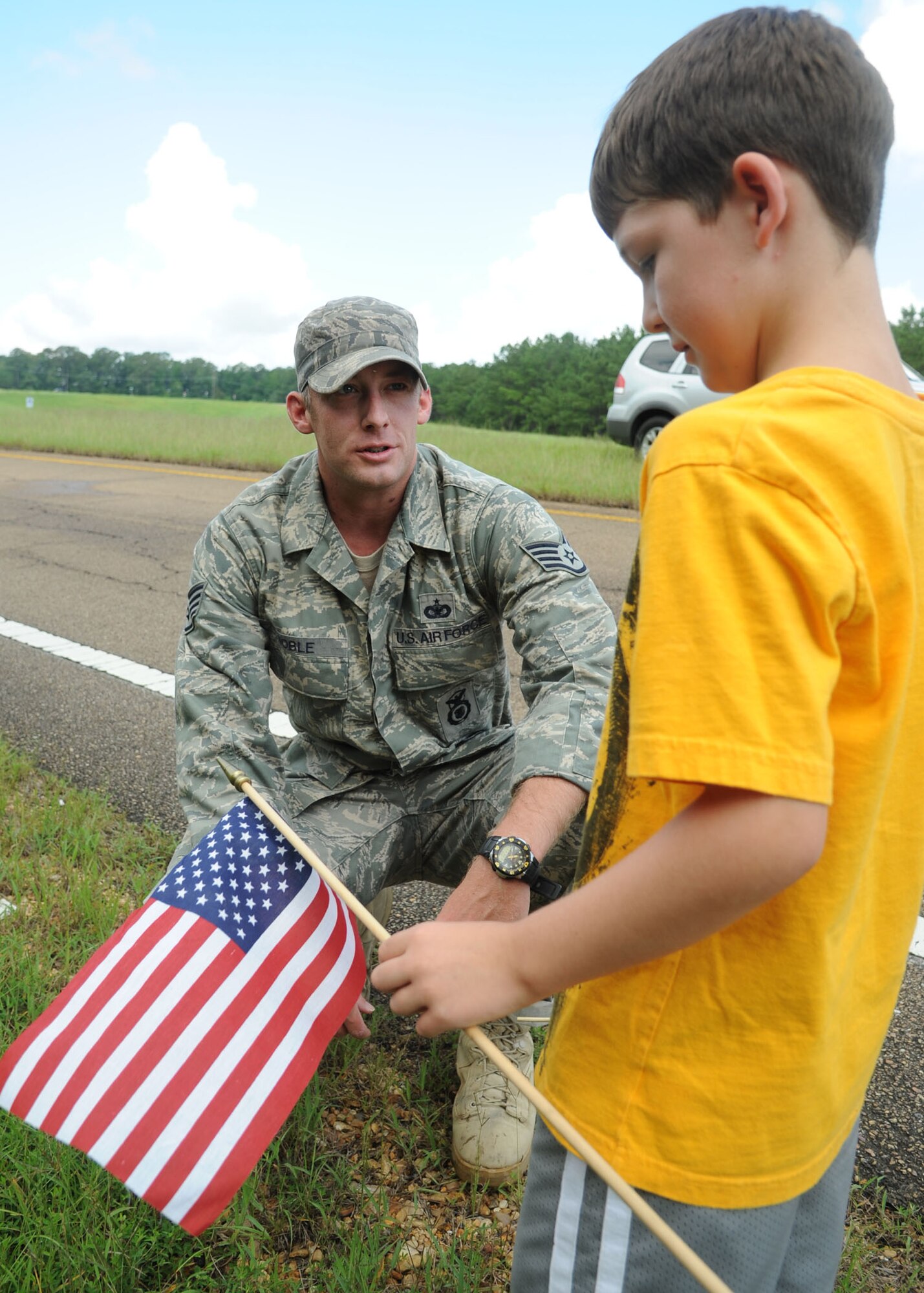 Staff Sgt. William Noble, 14th Security Forces Squadron, takes a moment on July 27 to speak with Ty Whittaker, a resident of Meadville, Miss. (U.S. Air Force photo/Airman 1st Class Chase Hedrick)