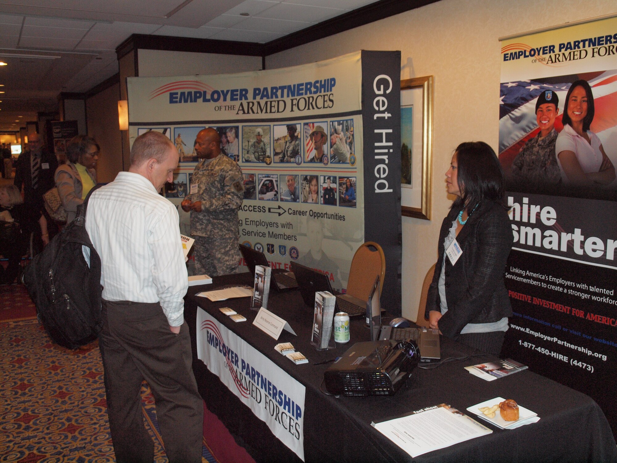 Human resources managers visit the Employer Partnership of the Armed Forces booth and learn how the program can help them find veteran candidates for federal jobs during the Veterans Employment Symposium, July 27, 2011, in Washington, D.C. (U.S. Army photo/Army Lt. Col. Matthew J. Leonard)