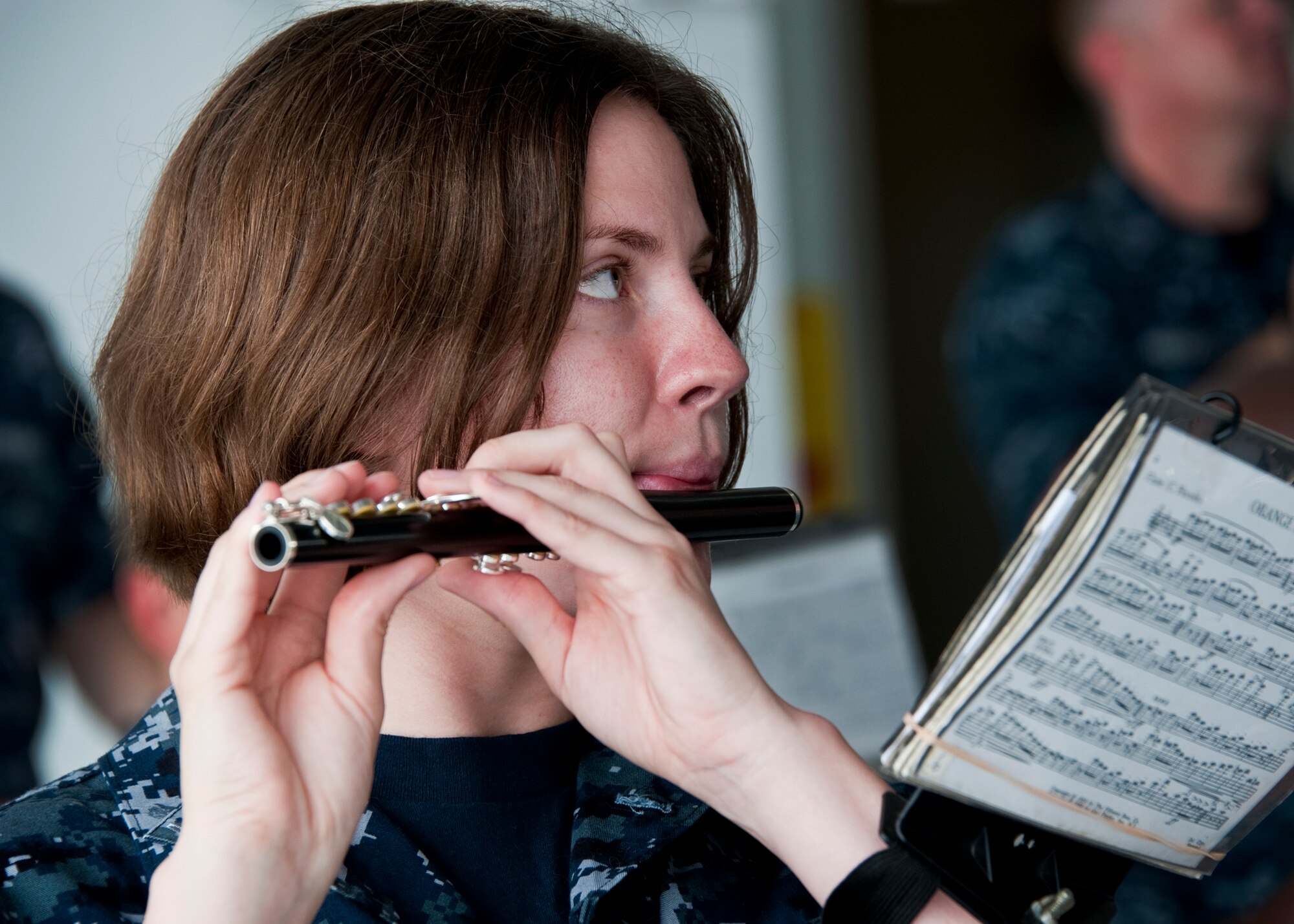 A flutist from the Navy Band of New Orleans watches the conductor prior to the 33rd Maintenance Group change of command, July 22 at Eglin Air Force Base, Fla.  (U.S. Air Force photo/Samuel King Jr.)